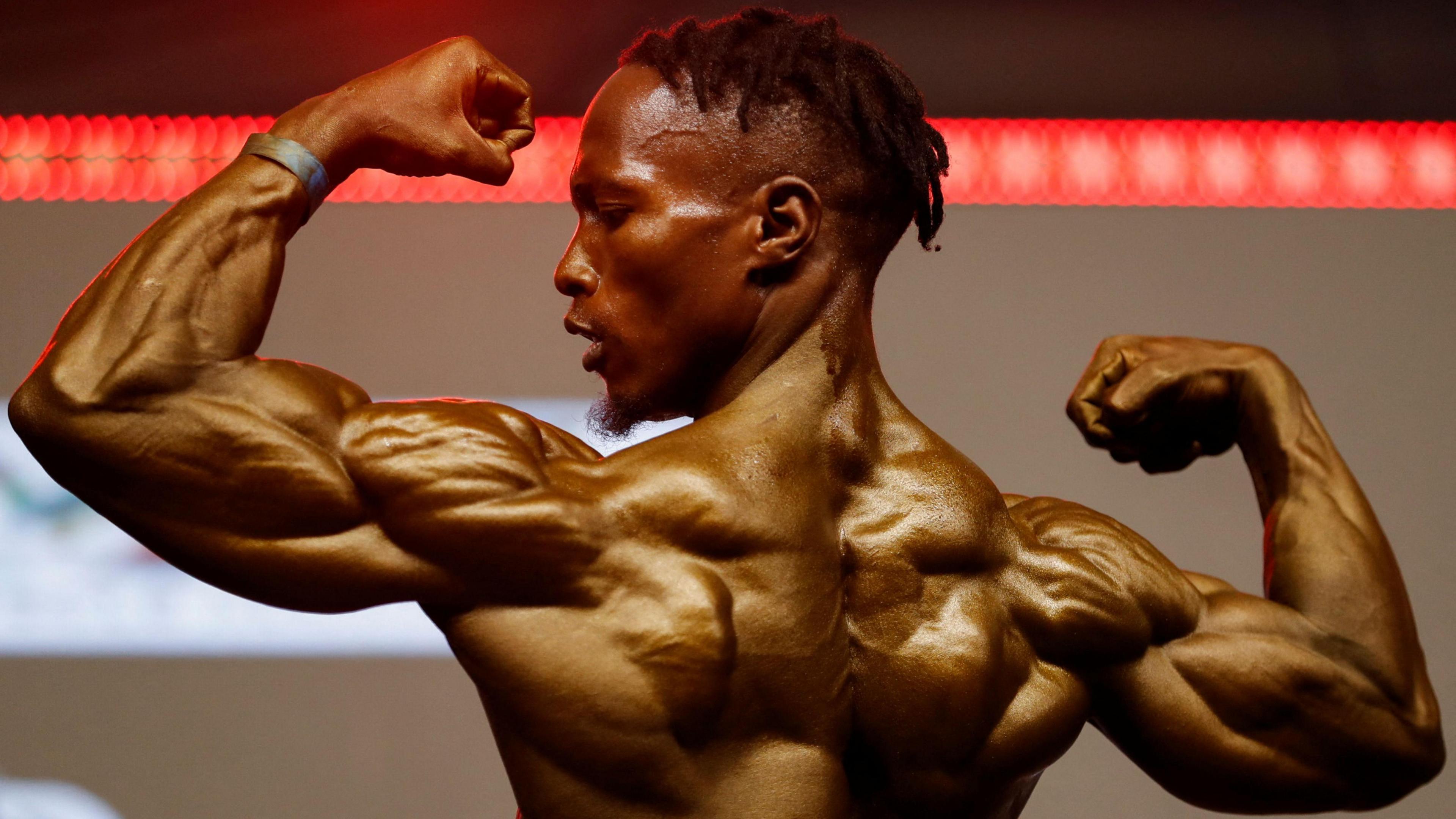 A muscled man displays his physique at the Mr and Miss East Africa Bodybuilding Contest at the Sarit Centre in Westlands district of Nairobi, Kenya - Saturday 13 October 2024