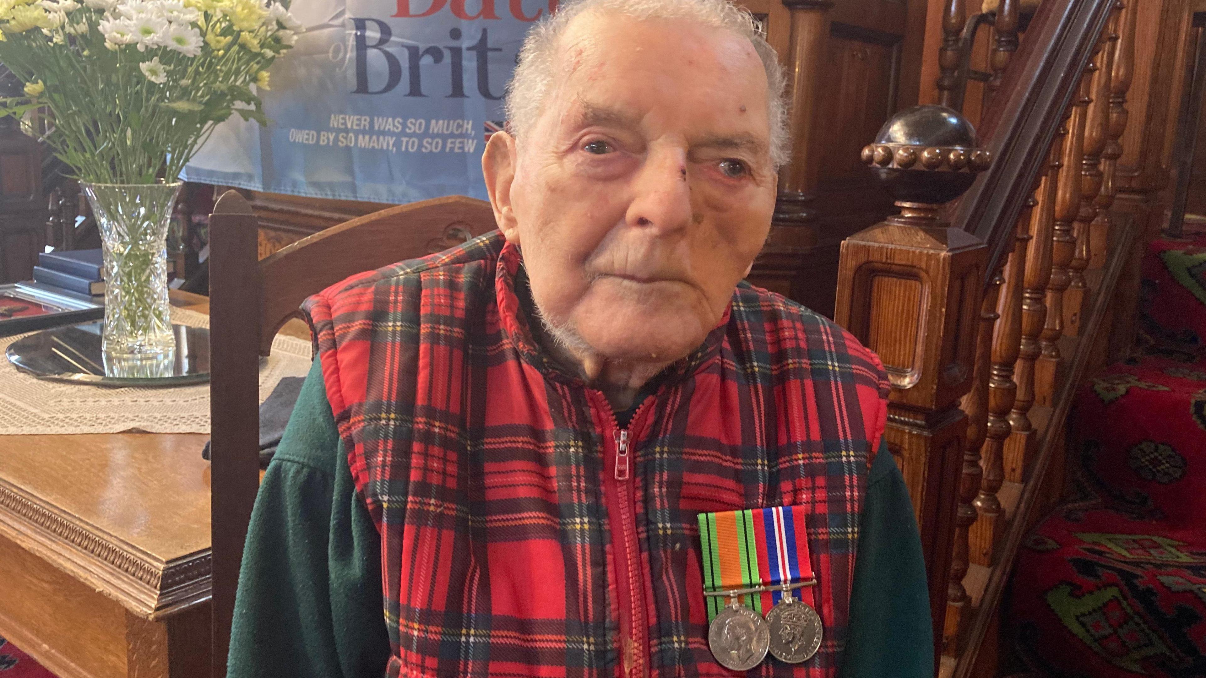  Basil Smith with his medals pinned to his checked body warmer