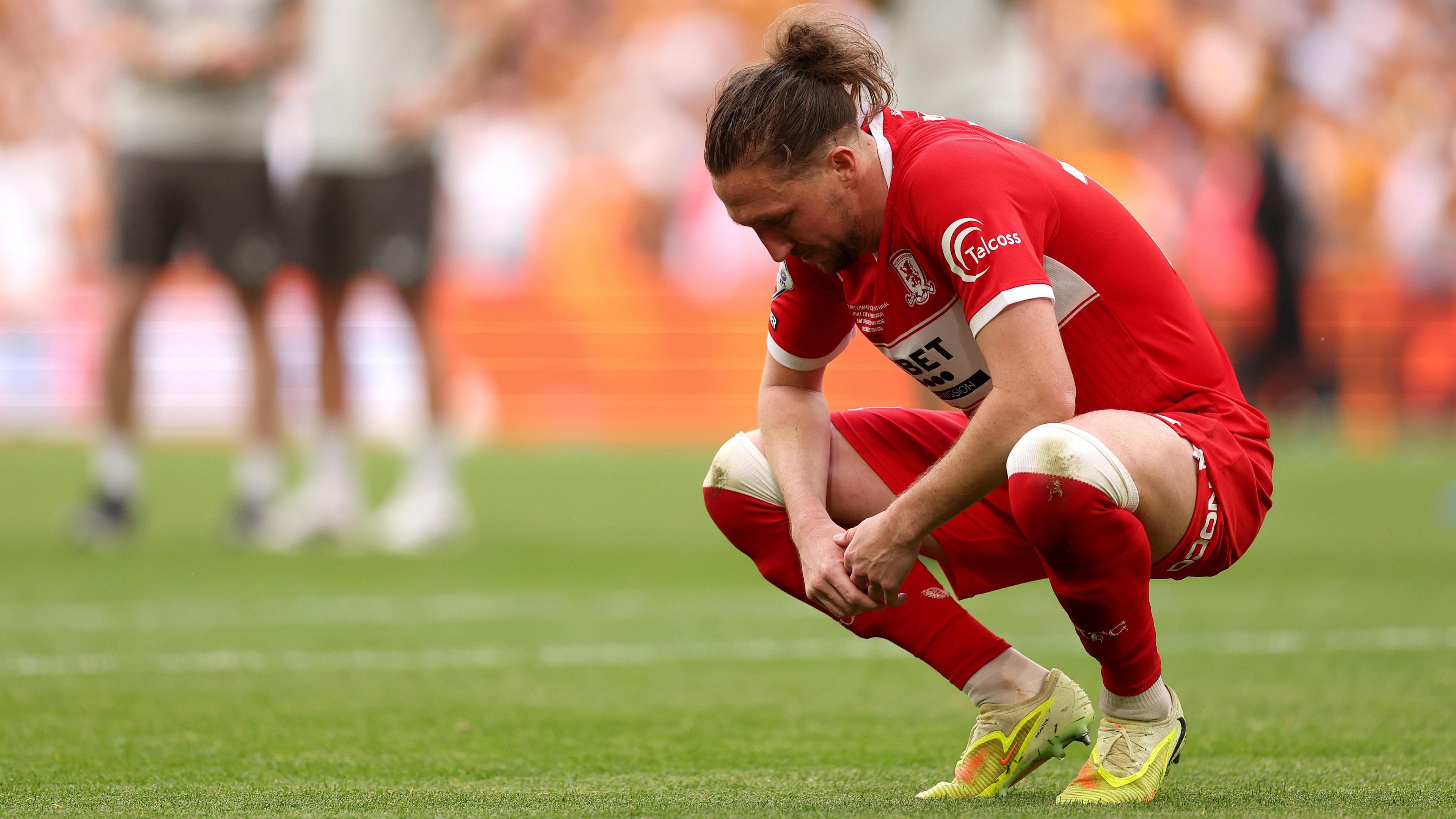 Luke Ayling alone in his thoughts and staring at the floor after Middlesbrough's play-off final defeat to Hull 