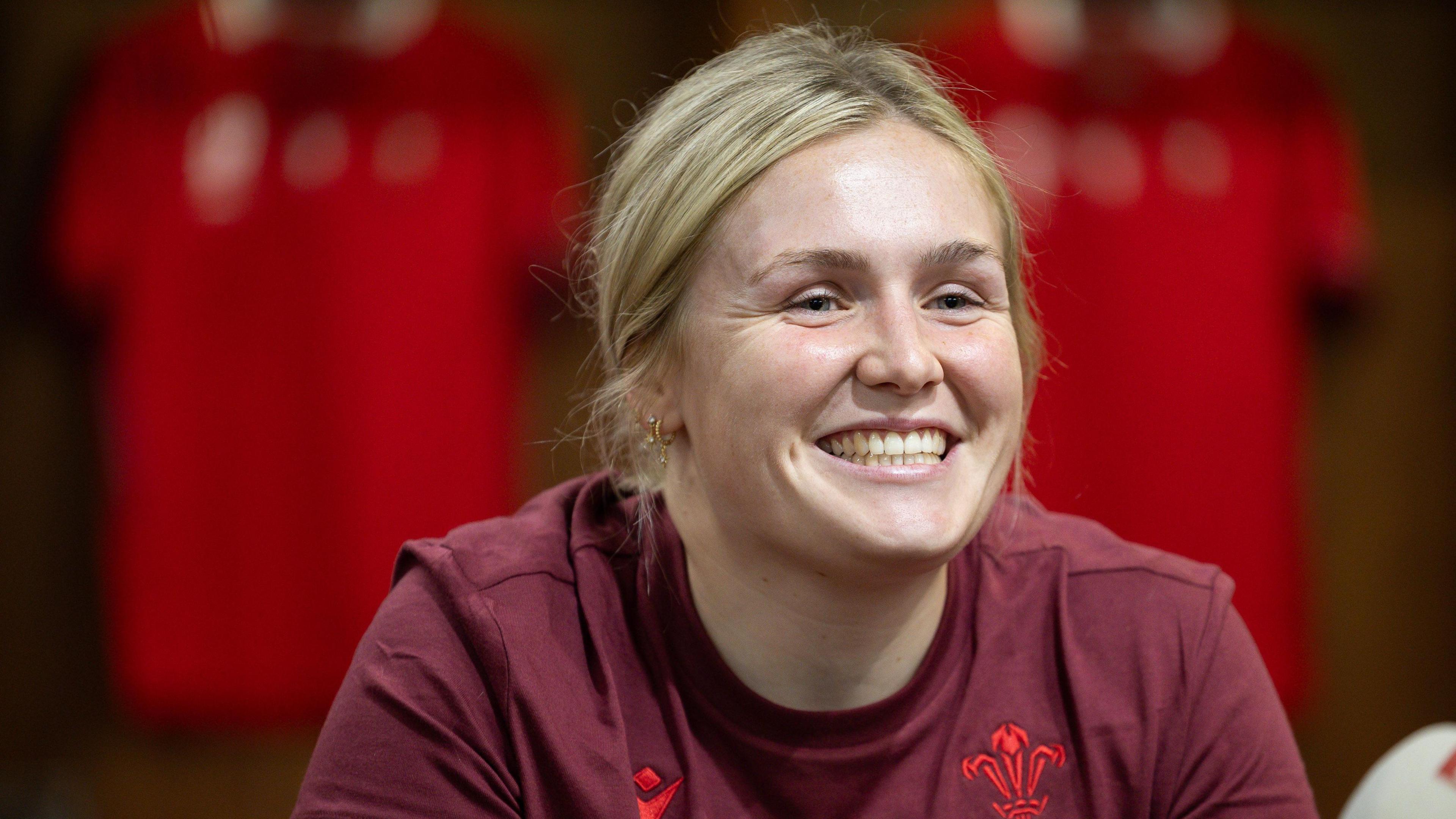 Alex Callender smiling at a press conference