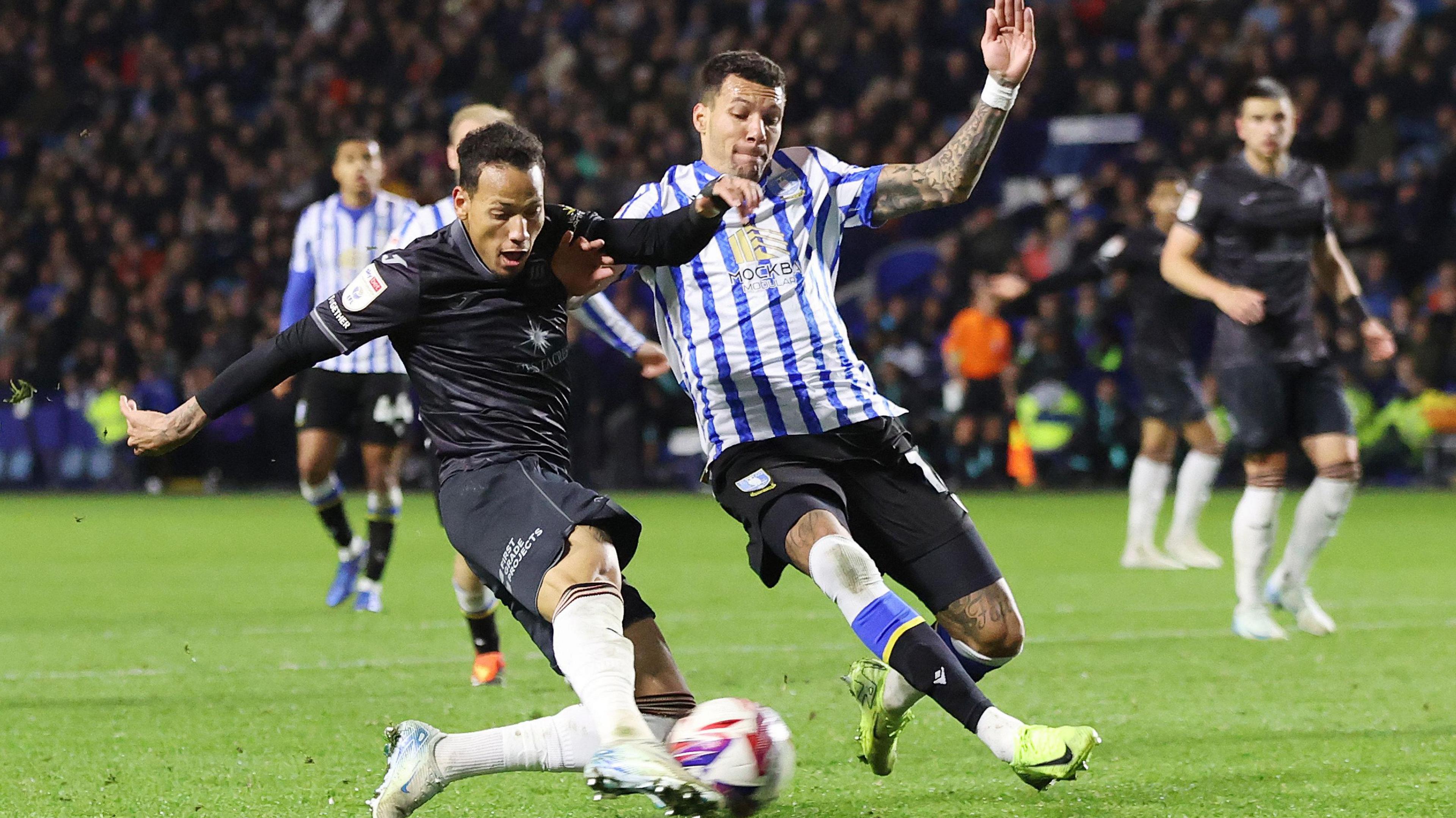 Ronald of Swansea tries a shot on goal as Marvin Johnson of Sheffield Wednesday attempts to block