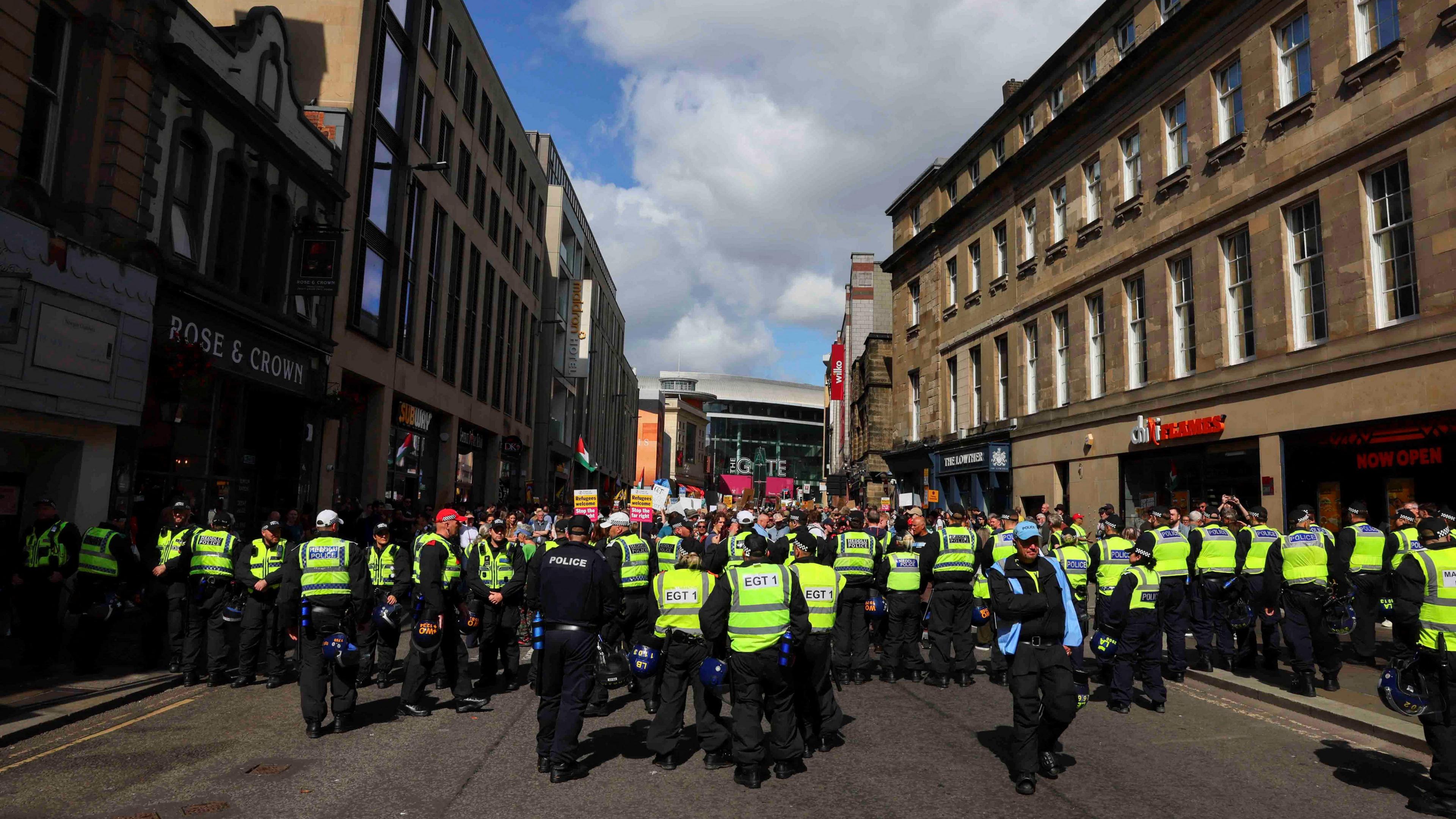 A line of police keep anti-racism demonstrators on Newcastle's Newgate Street