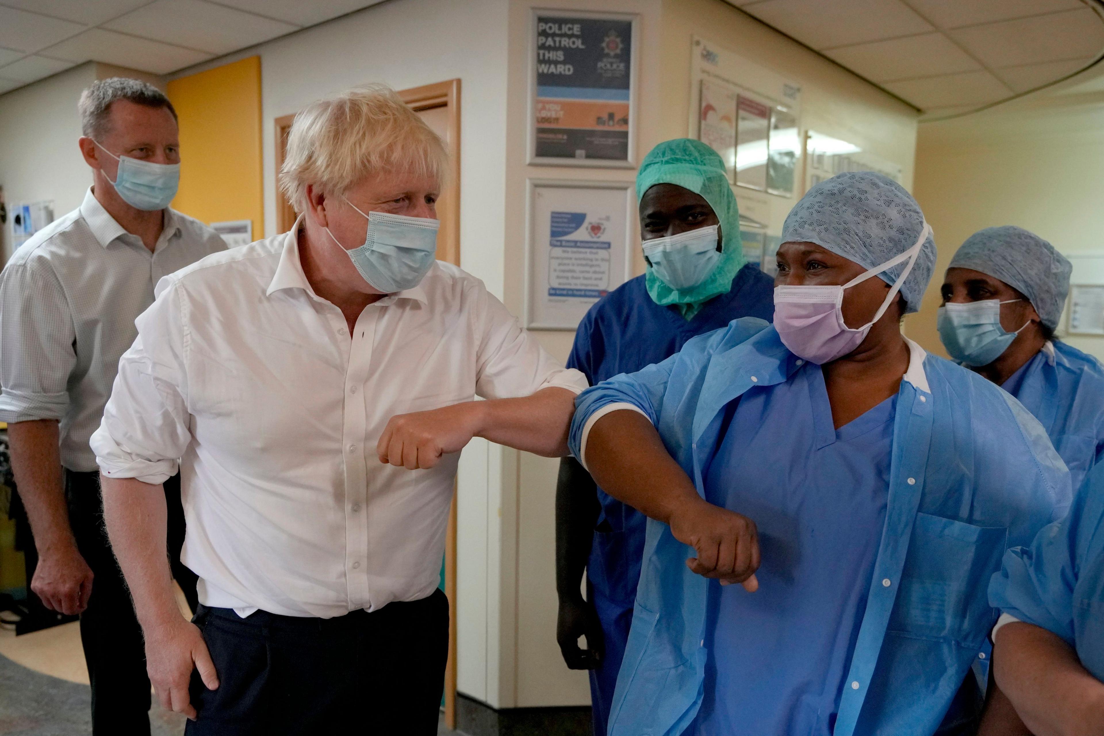 Then-Prime Minister Boris Johnson meets members of staff during a visit to the South West London Elective Orthopaedic Centre in Epsom on 26 August 2022