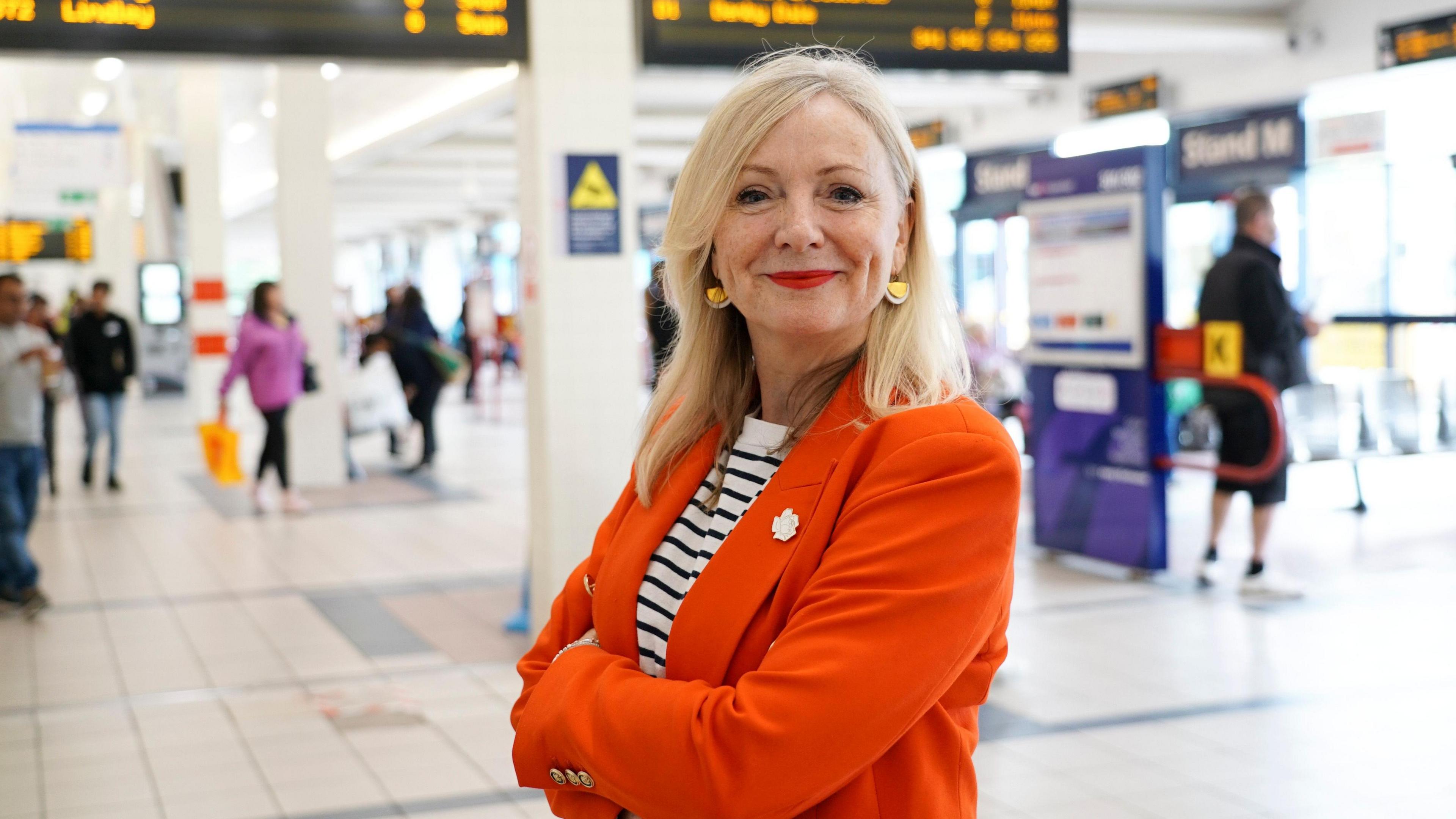 West Yorkshire Mayor Tracy Brabin standing with folded arms in Huddersfield Bus Station.