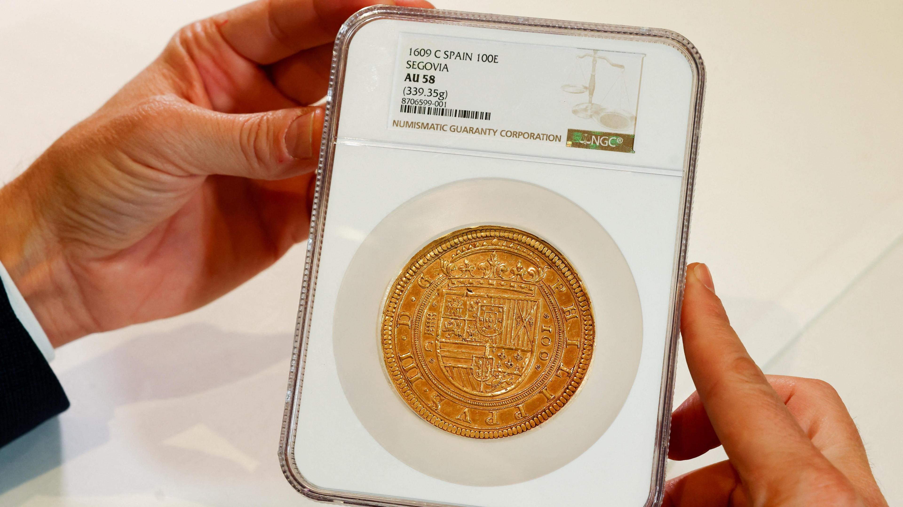 Gold coin in a plastic case.