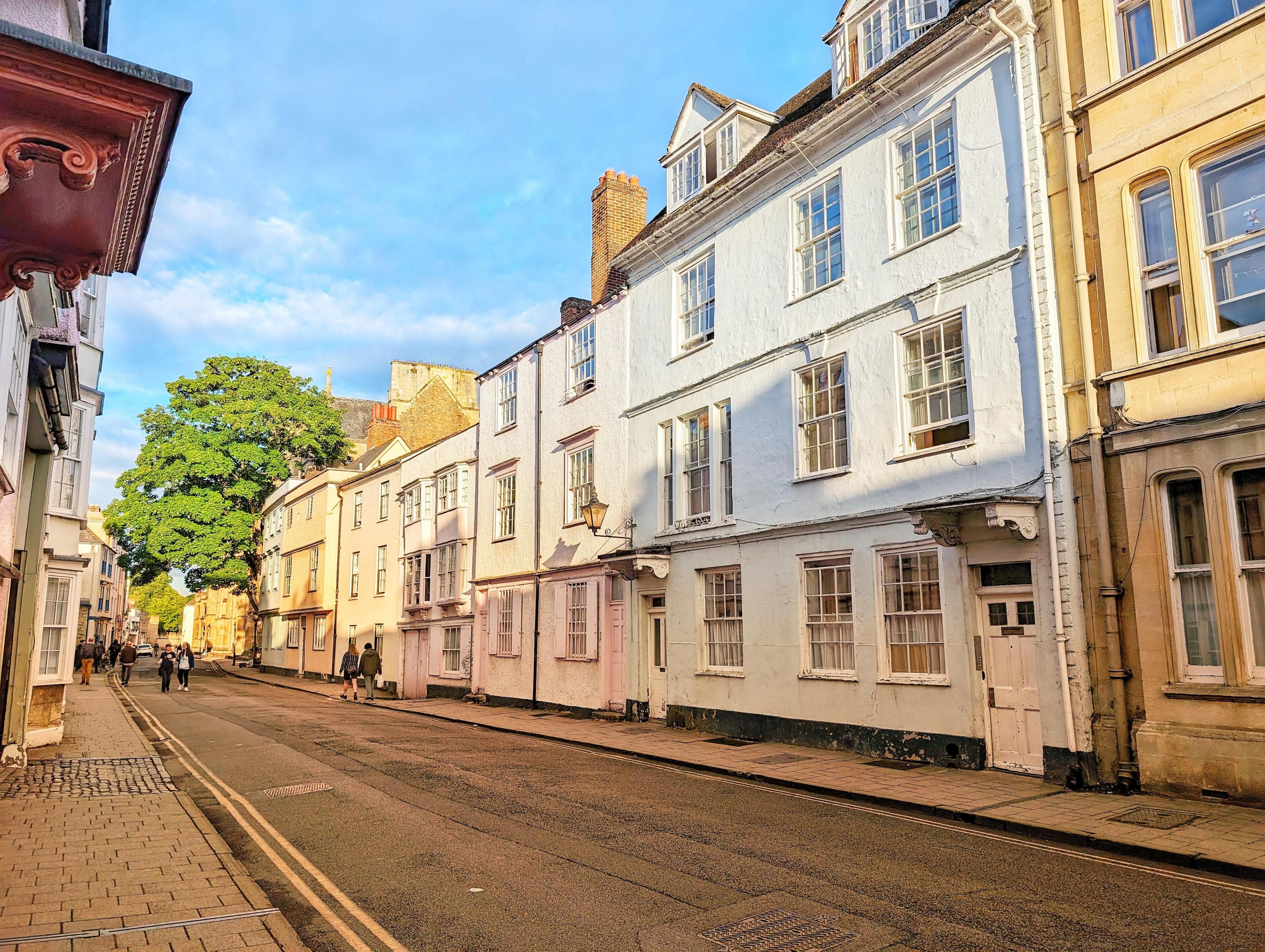 A quiet street in Oxford with shadows over the buildings