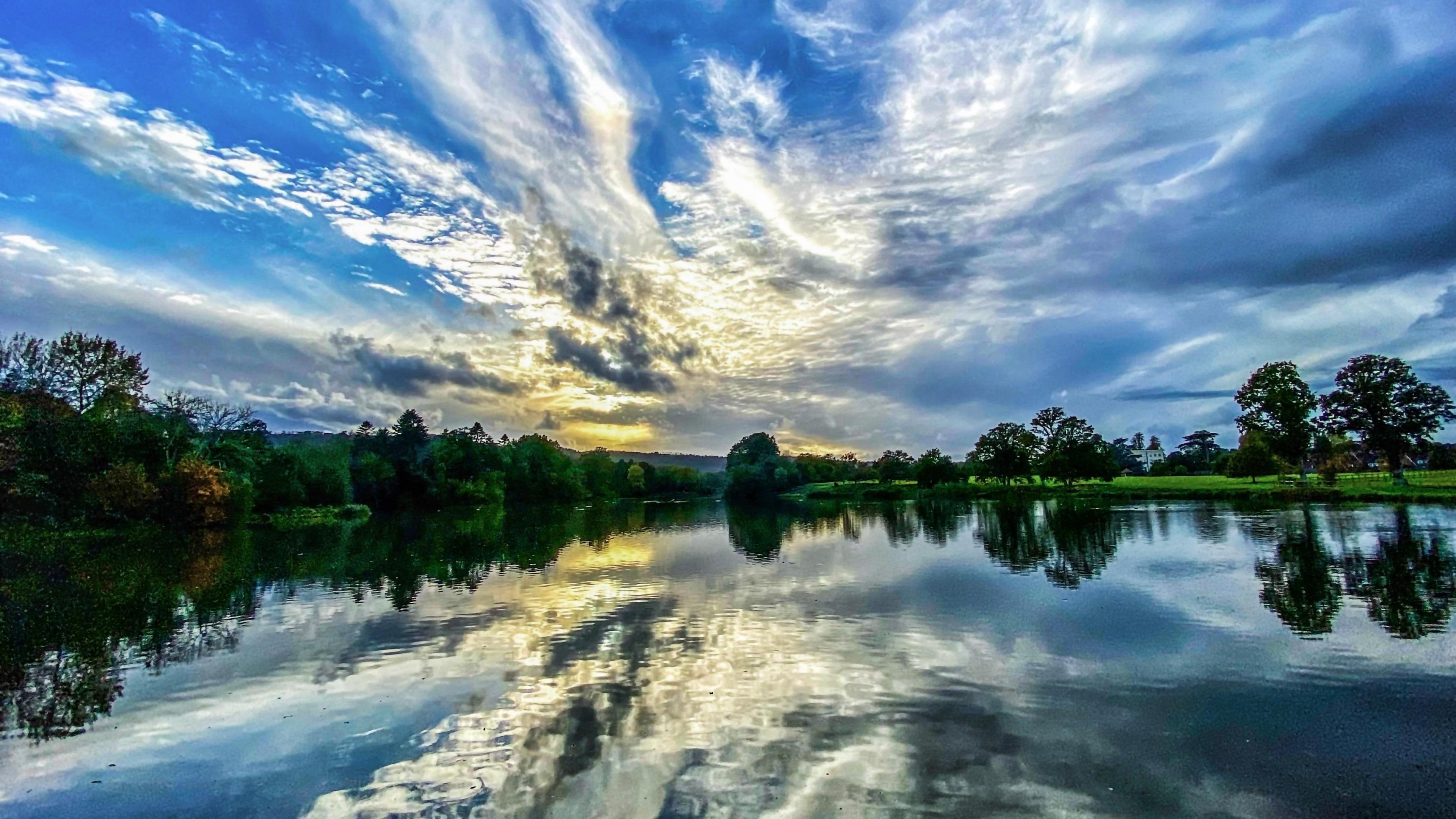 A dramatic cloudy sky reflected in a still body of water