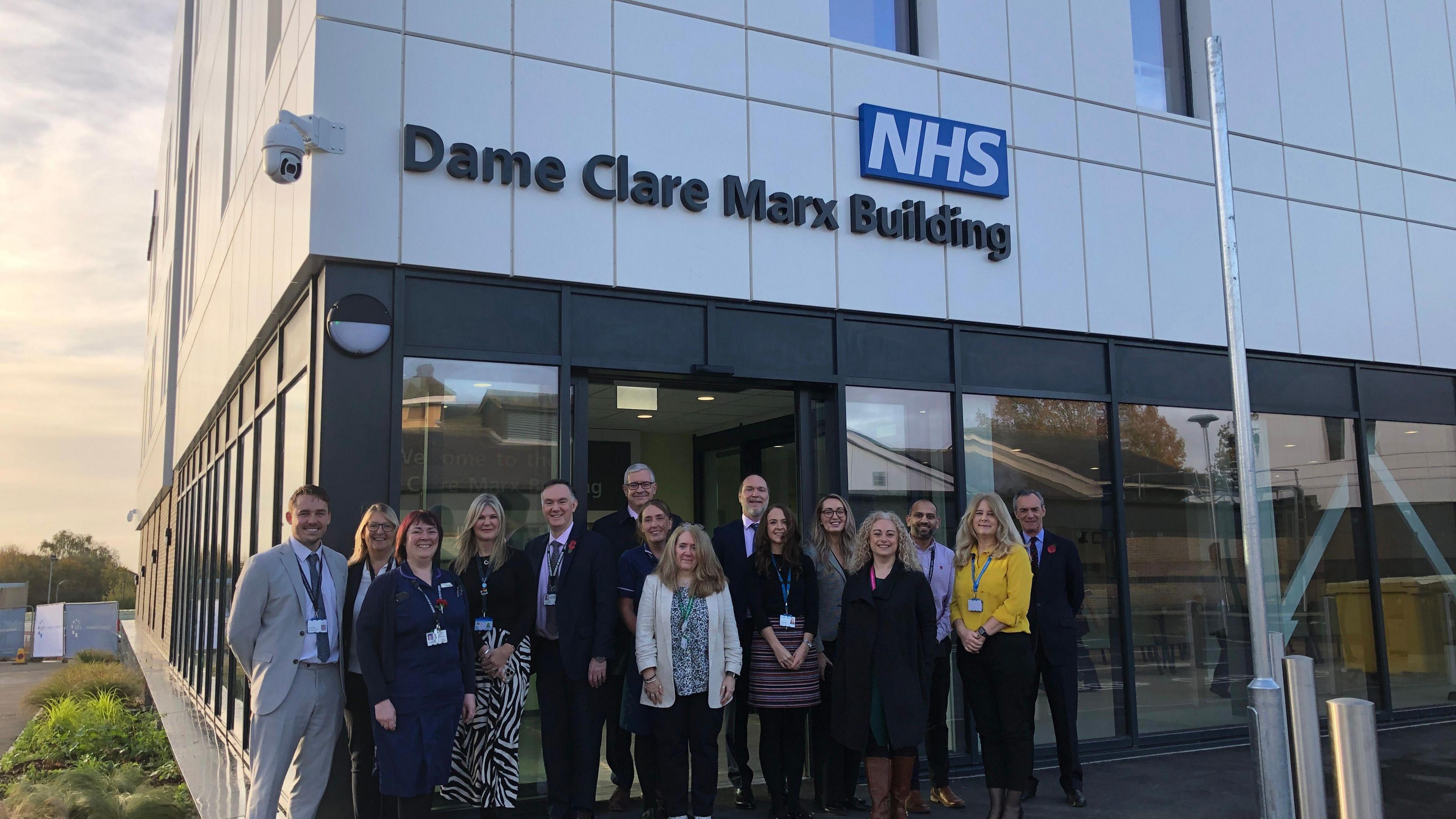 Men and woman standing outside the new Essex and Suffolk Elective Orthopaedic Centre