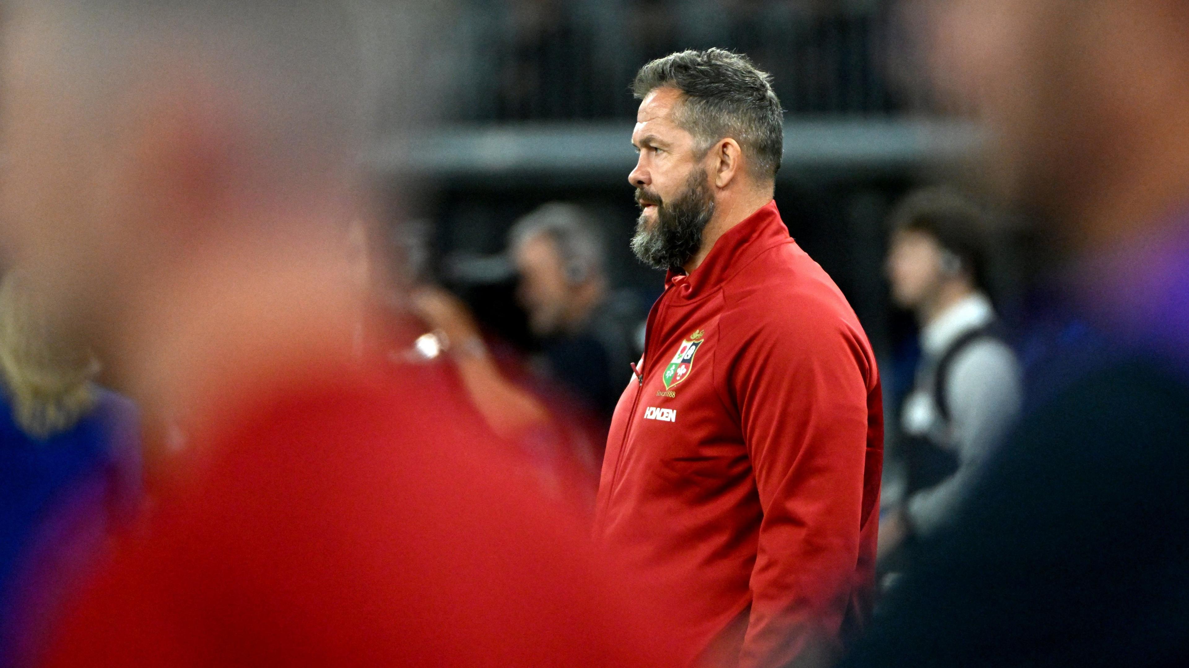 Andy Farrell, pictured sideways on, looks out to the left of frame, with two blurred figures in the foreground