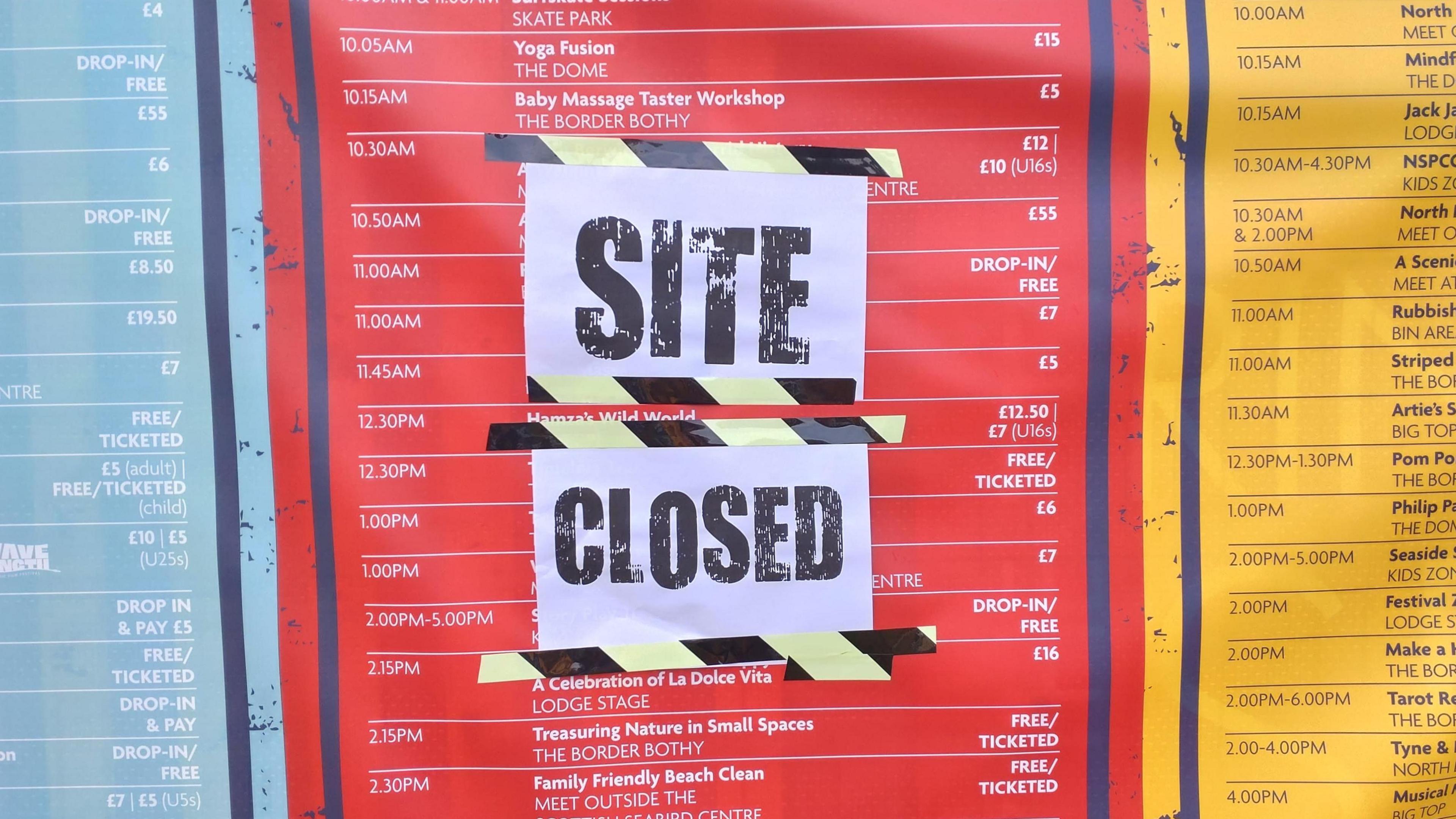 A red, blue and yellow poster showing an itinerary of events with paper taped over it saying SITE CLOSED