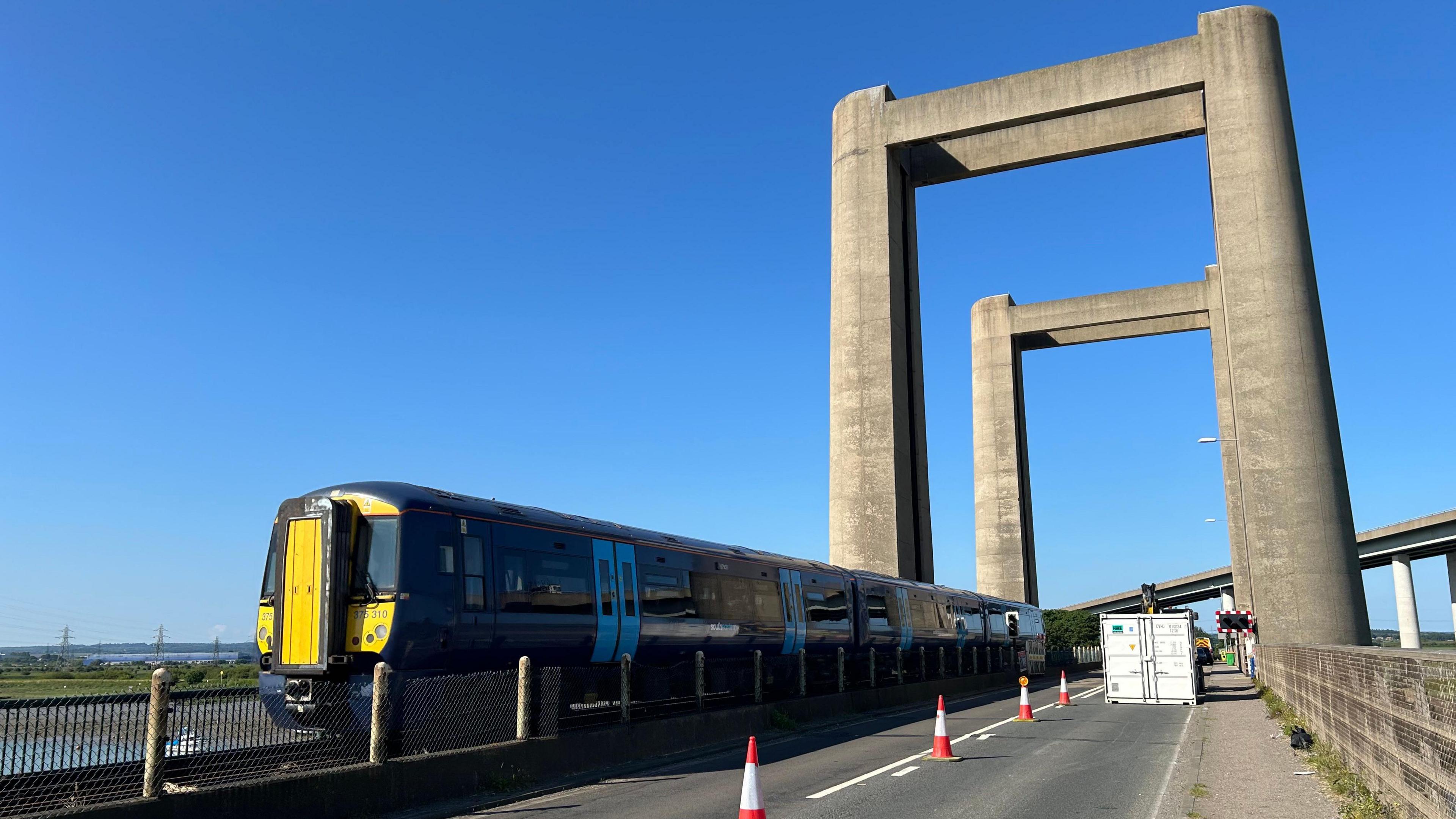 A train crossing the Kingsferry Bridge on a sunny day