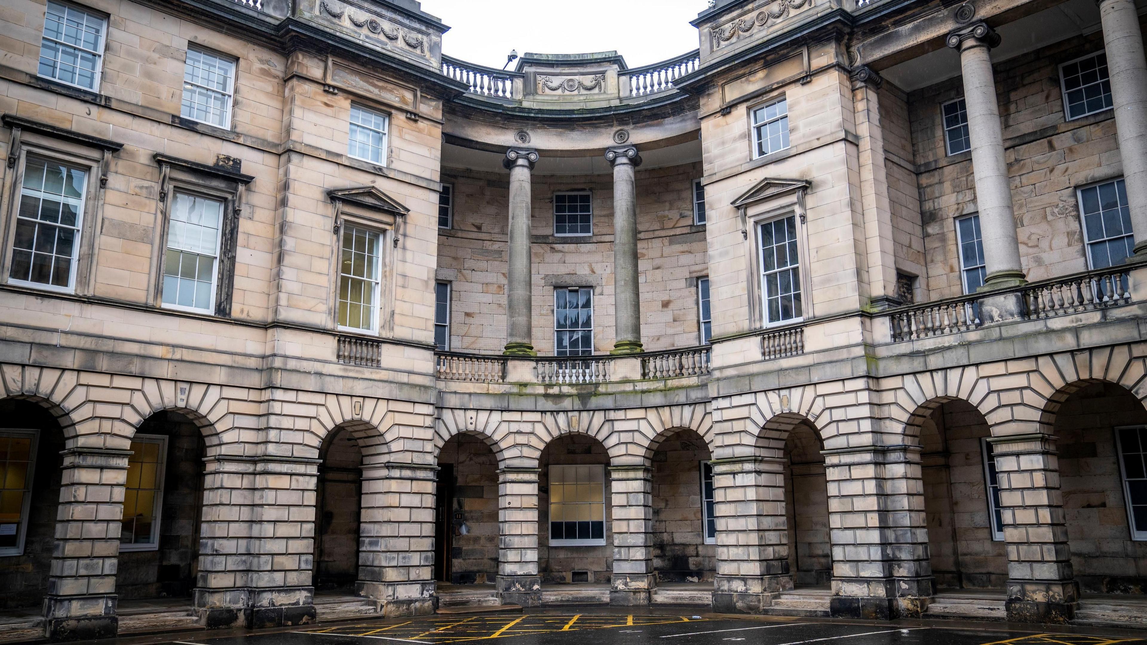 The Court of Session building in Edinburgh - an old stone building with lots of pillars and windows 