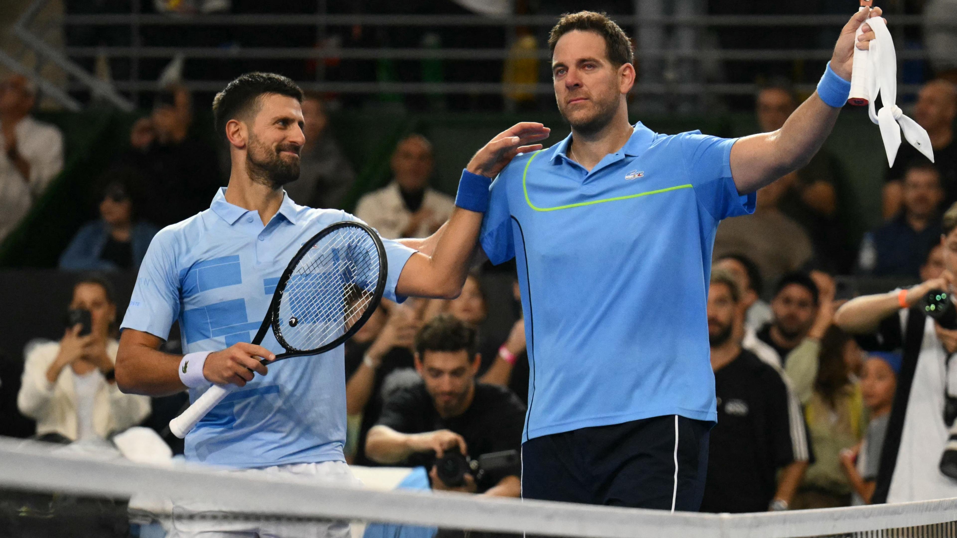 Novak Djokovic and Juan Martin del Potro at the end of their exhibition match