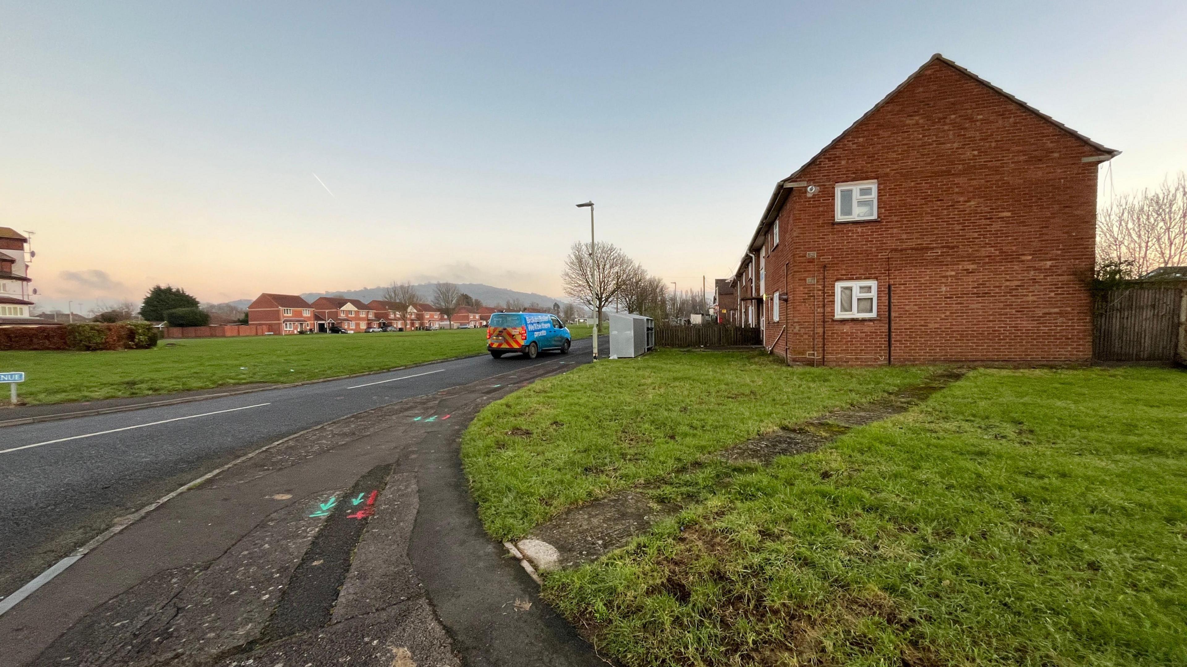 Houses in podsmead in front of a green