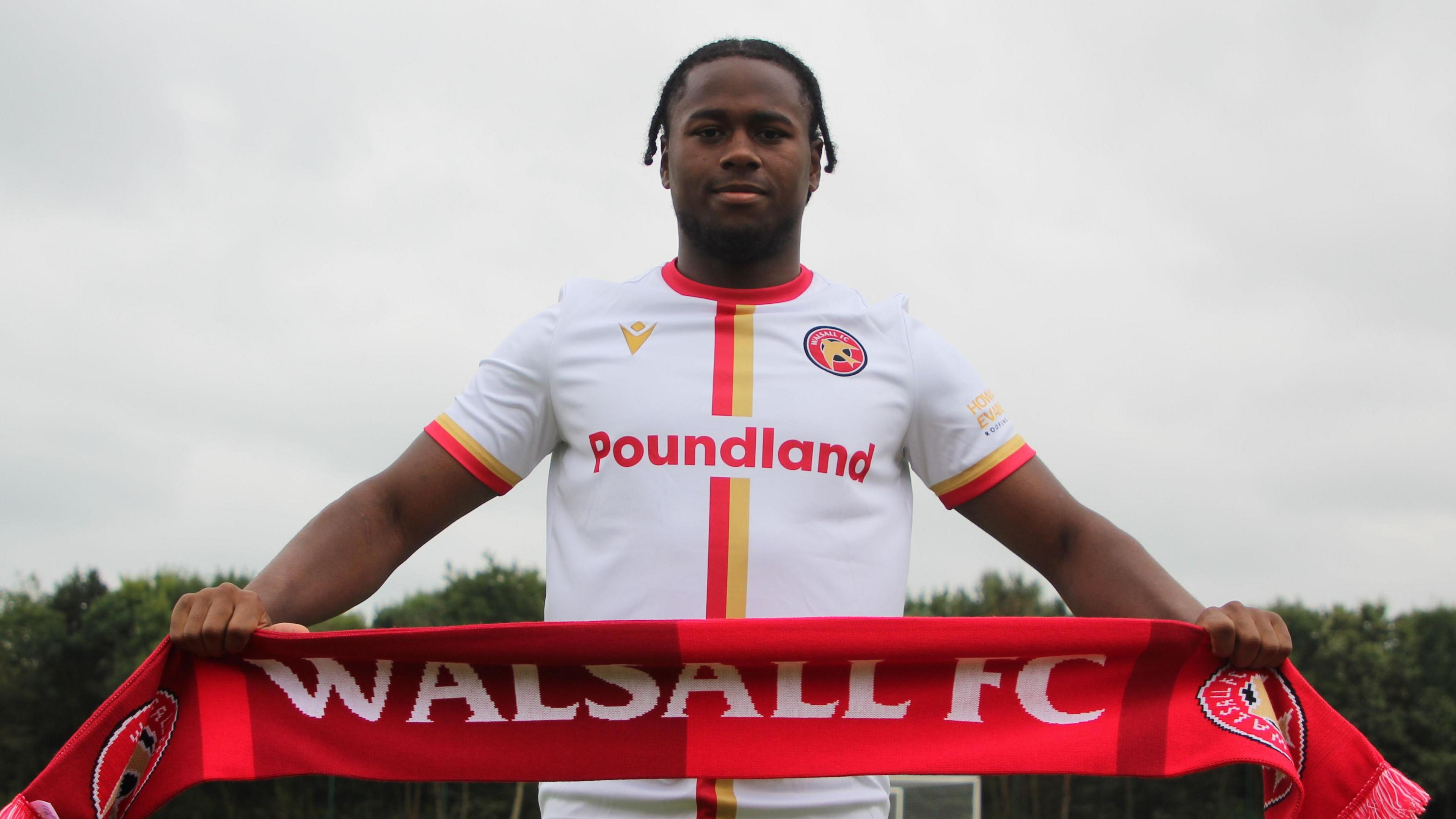 Reyes Cleary holding a Walsall scarf