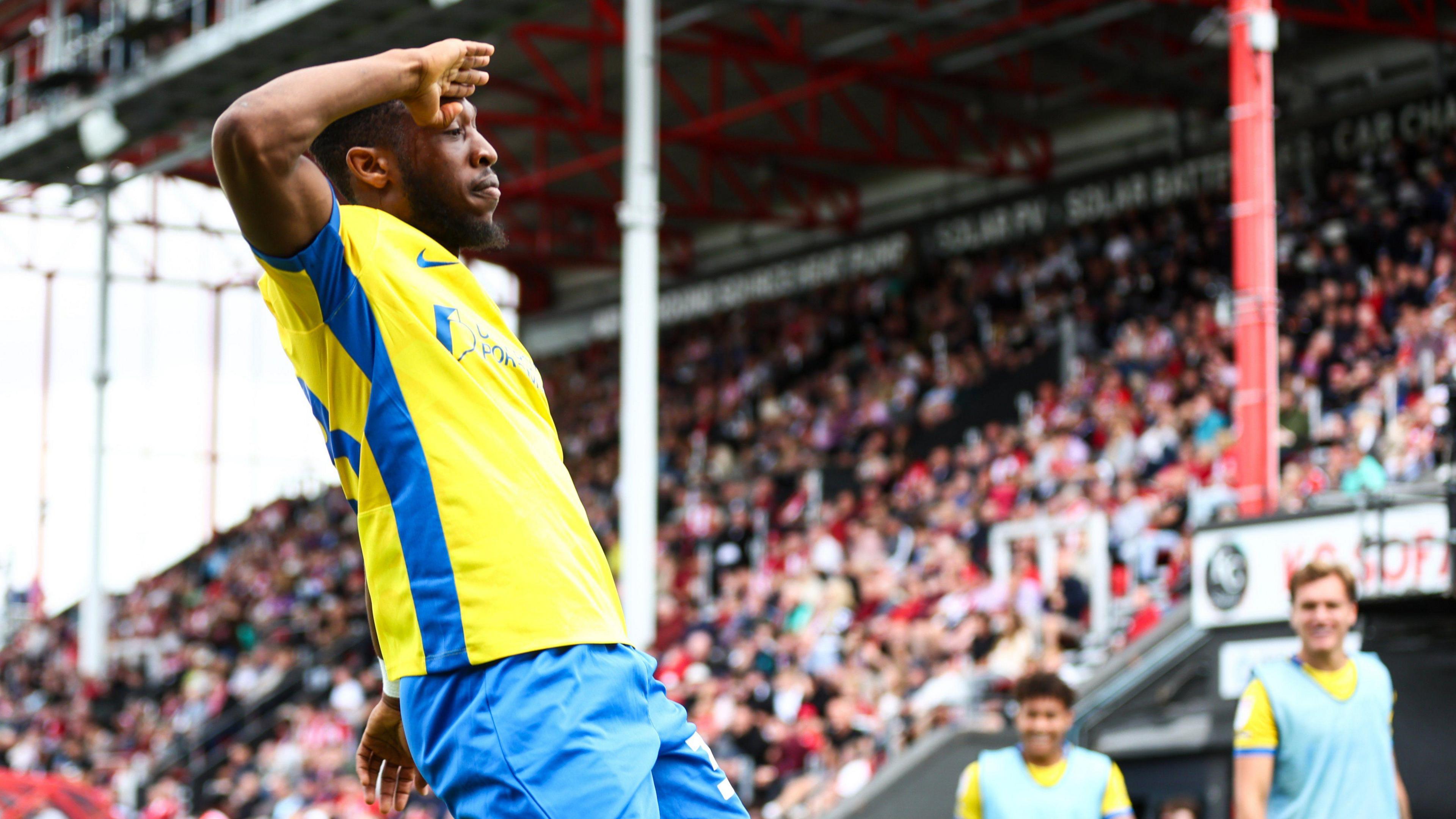 Portsmouth midfielder Ebou Adams salutes the crowd after scoring against Lincoln City in the Championship