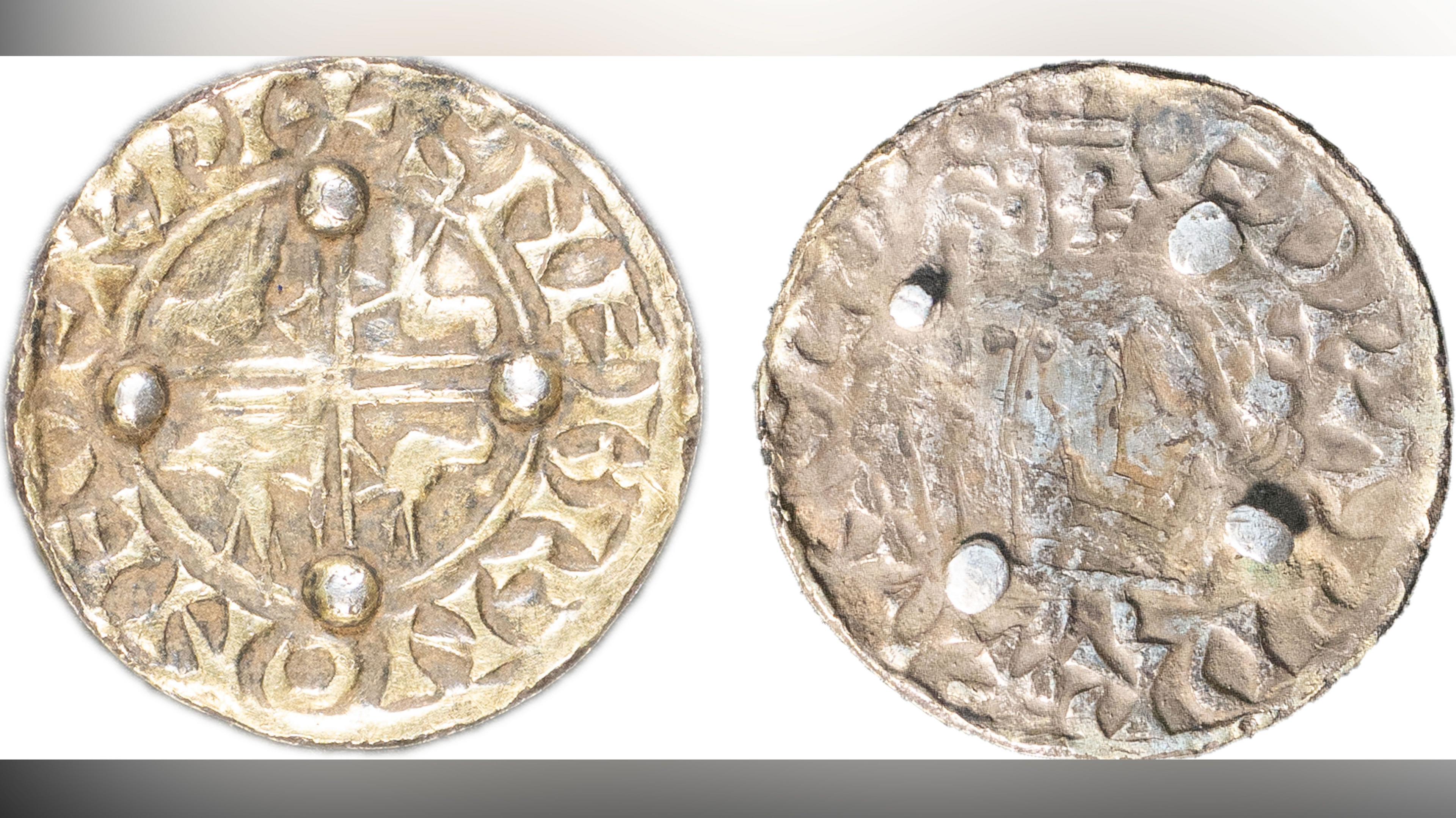 Edward the Confessor coin brooch. Both sides are shown with the front depicting a cross with birds in each quarter and the back showing four blobs, where the pin and fastening would once have been 