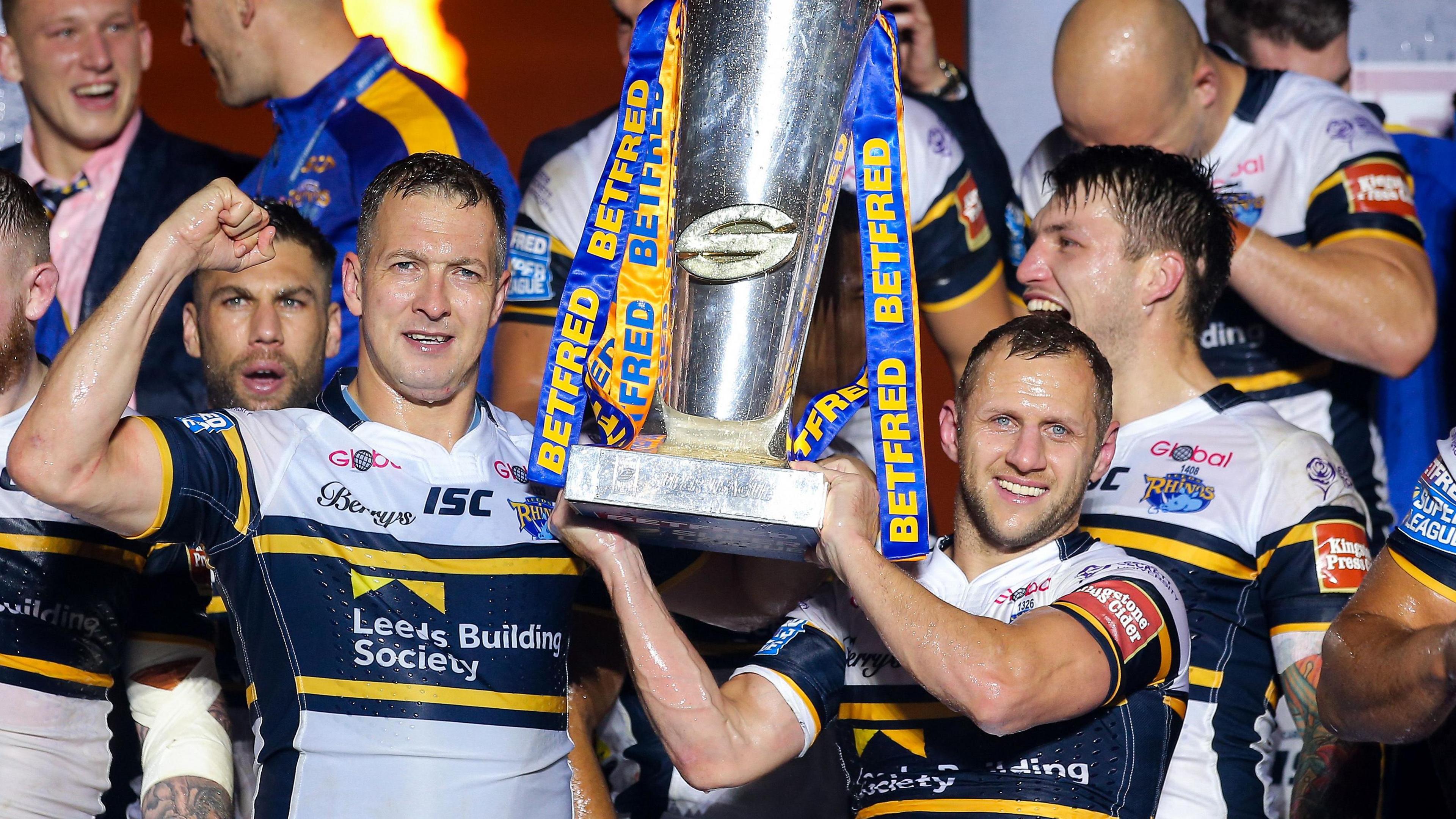 Rob Burrow lifts the Super League trophy with Danny McGuire