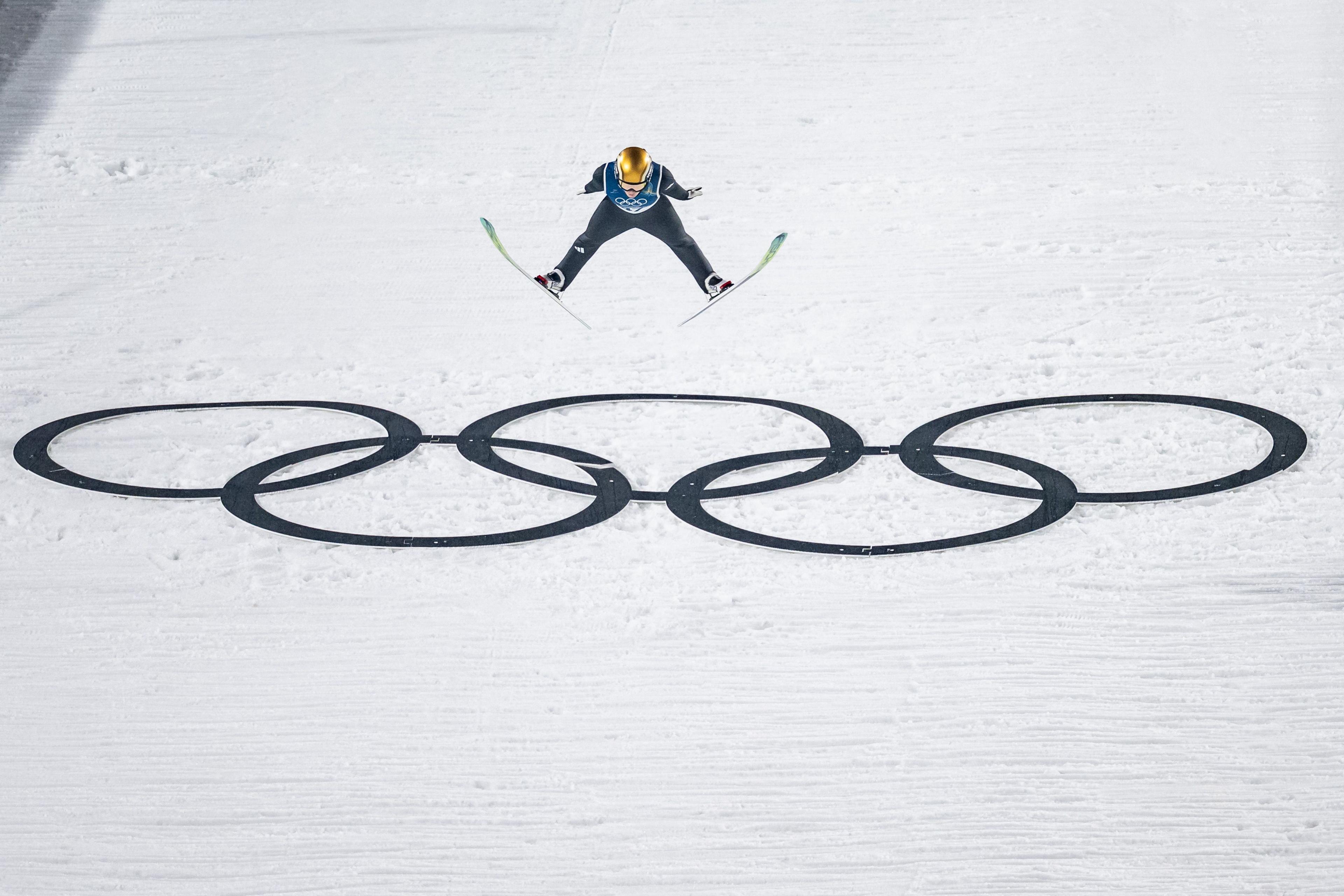 Slovenian Nika Prevc jumps over the Olympic rings at Val di Fiemme