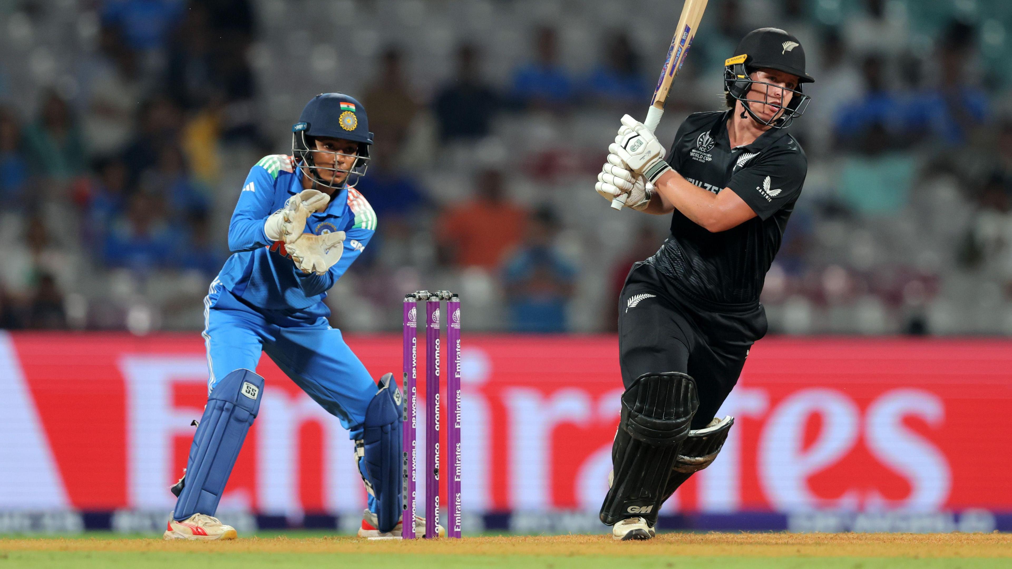 Brooke Halliday of New Zealand bats as wicket keeper Richa Ghosh of India looks on during the ICC Women's Cricket World Cup India 2025 match between India and New Zealand at DY Patil Stadium on October 23, 2025 in Navi Mumbai, India.