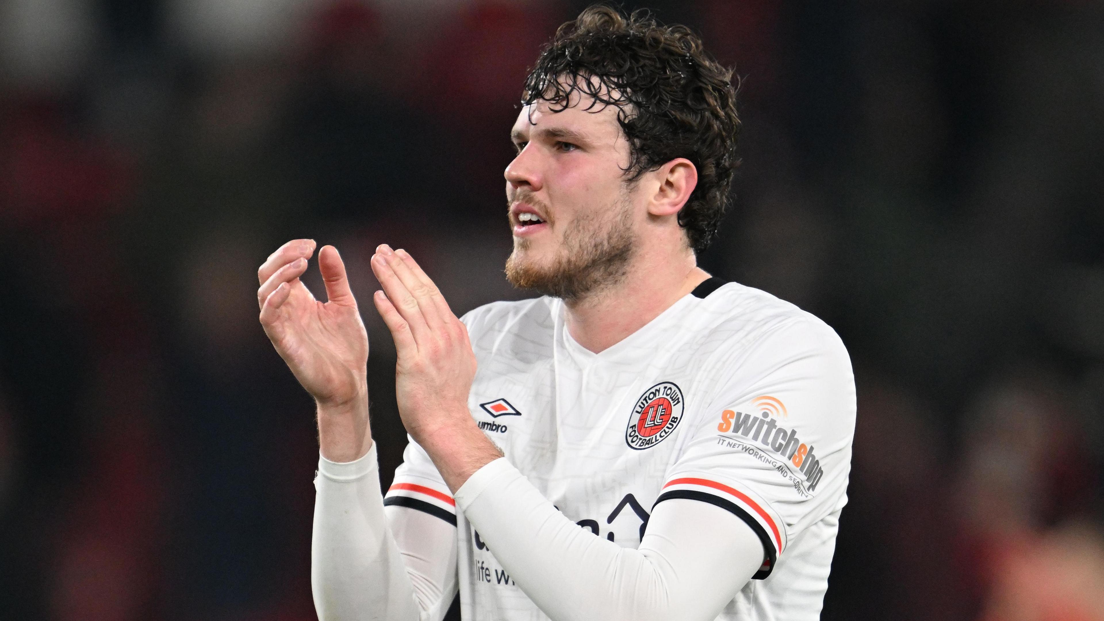 Thomas Holmes claps fans while playing for Luton