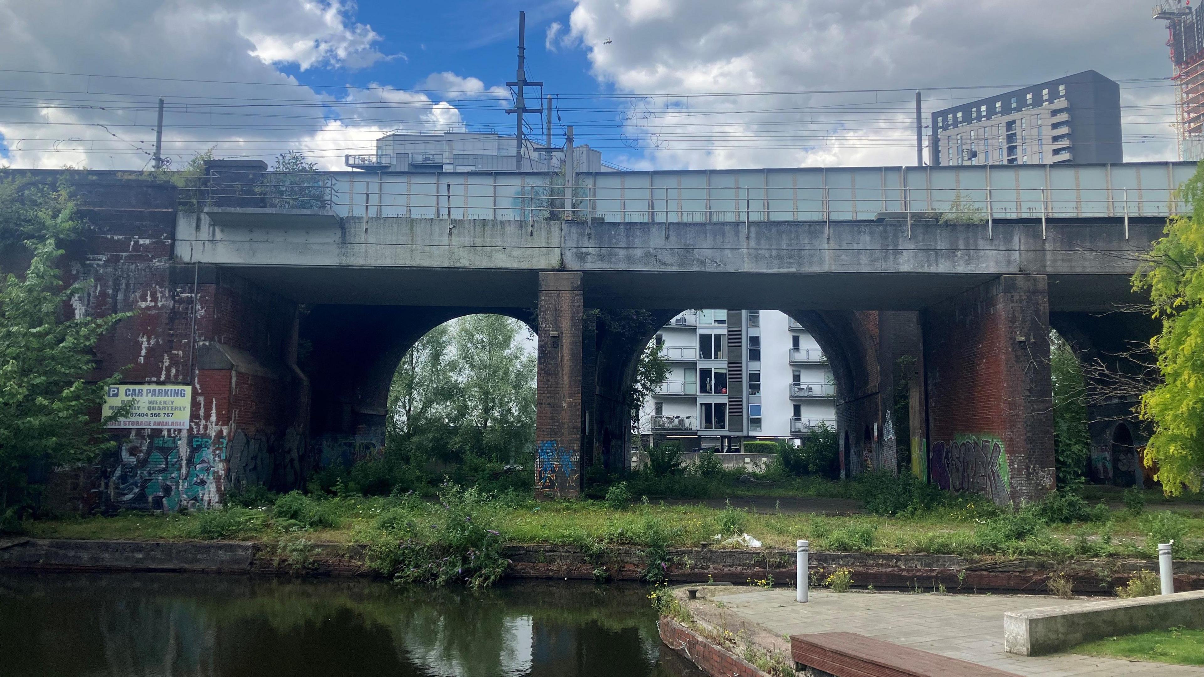 Photograph of a series of railway arches next to canals in Castlefield on the edge of Manchester city centre.