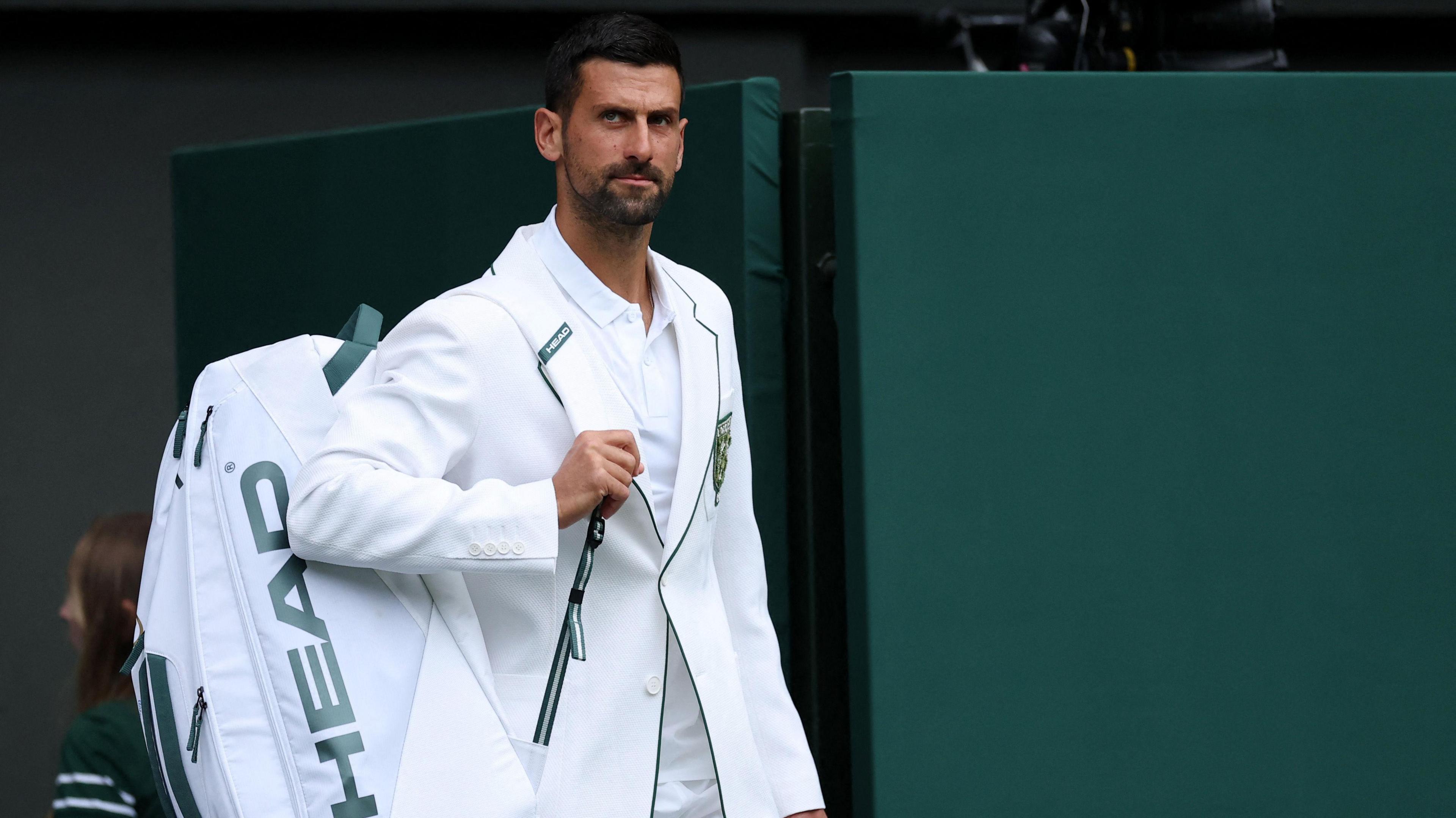 Serbia's Novak Djokovic walks onto the court ahead of his first round match against China's Yibing Wu