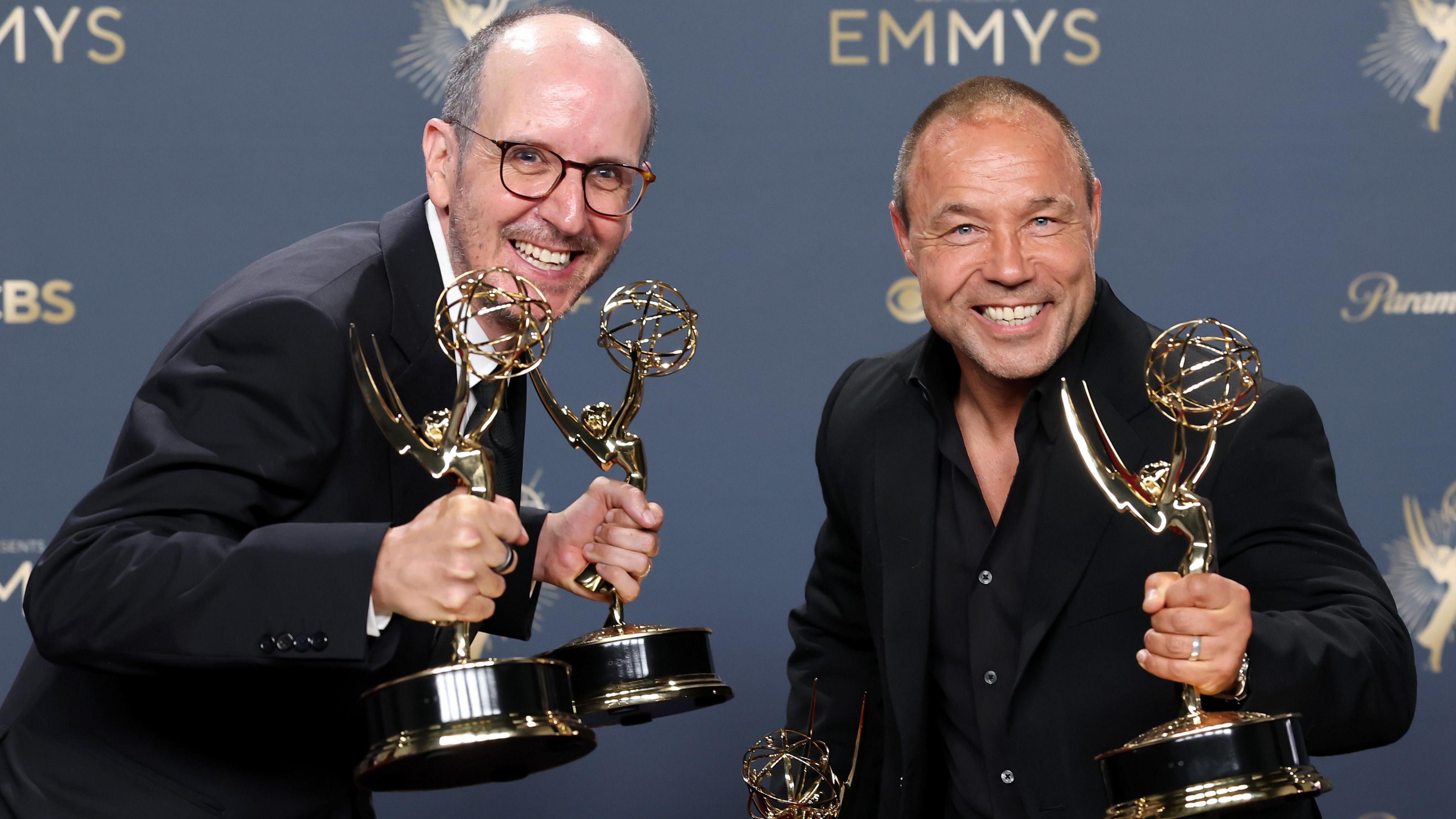 Jack Thorne and Stephen Graham pose in the press room with their Emmy awards at the ceremony earlier this month in Los Angeles. They are both grinning and wearing black suits.