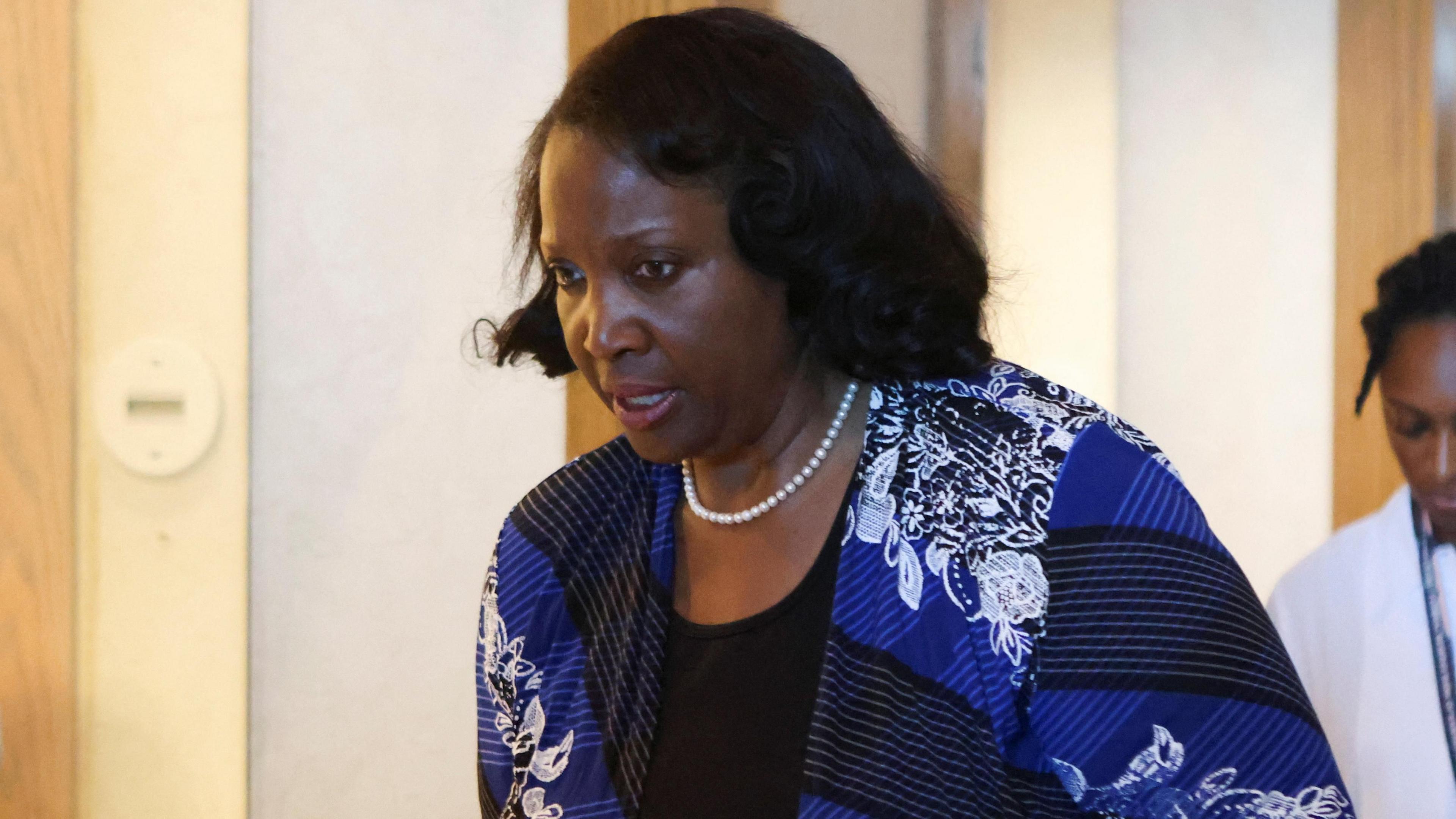 Federal Reserve Governor Lisa Cook wearing a blue top and pearl necklace