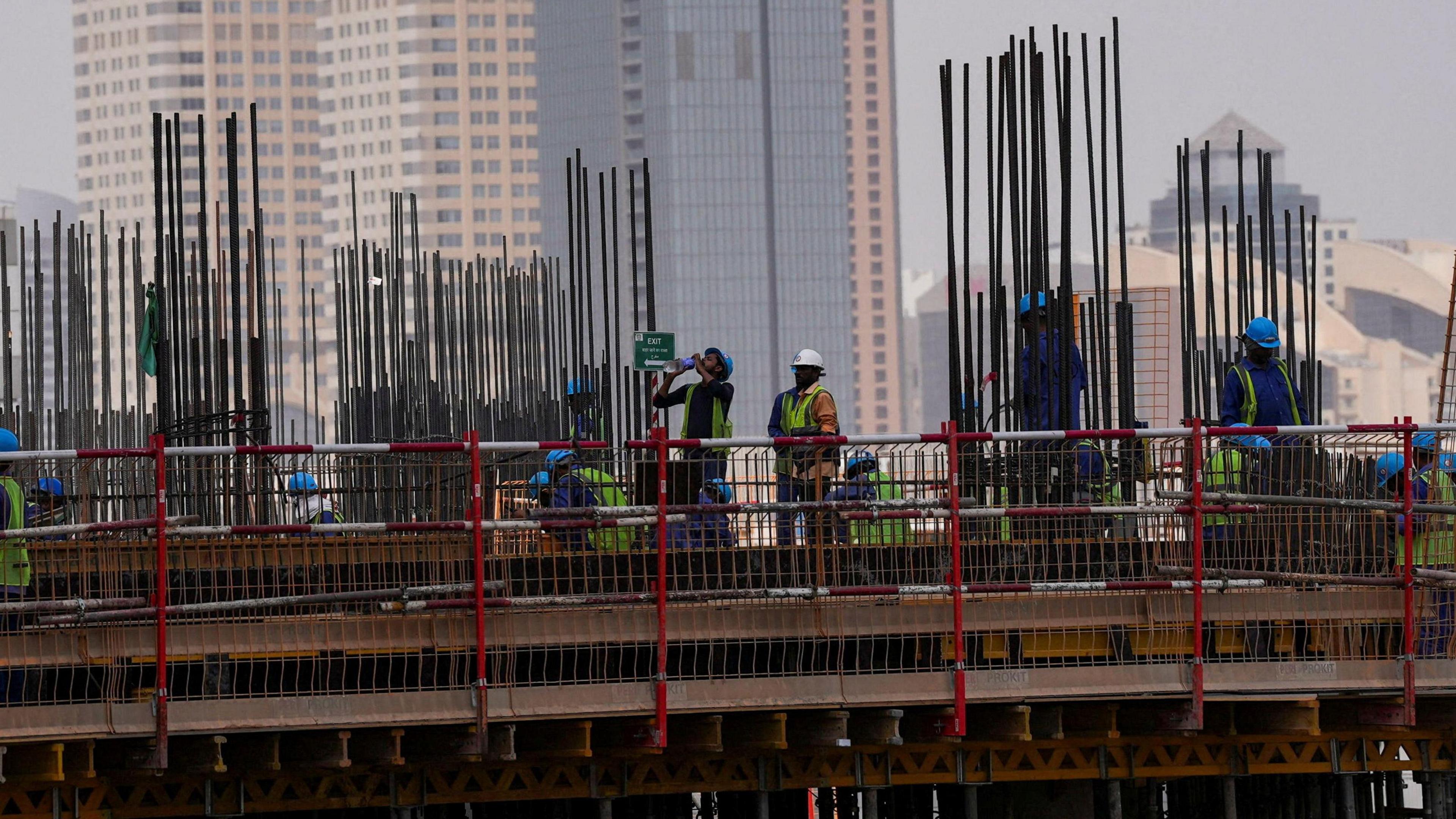 A worker drinks water as he works during a heatwave in Dubai, United Arab Emirates, August 2, 2025.