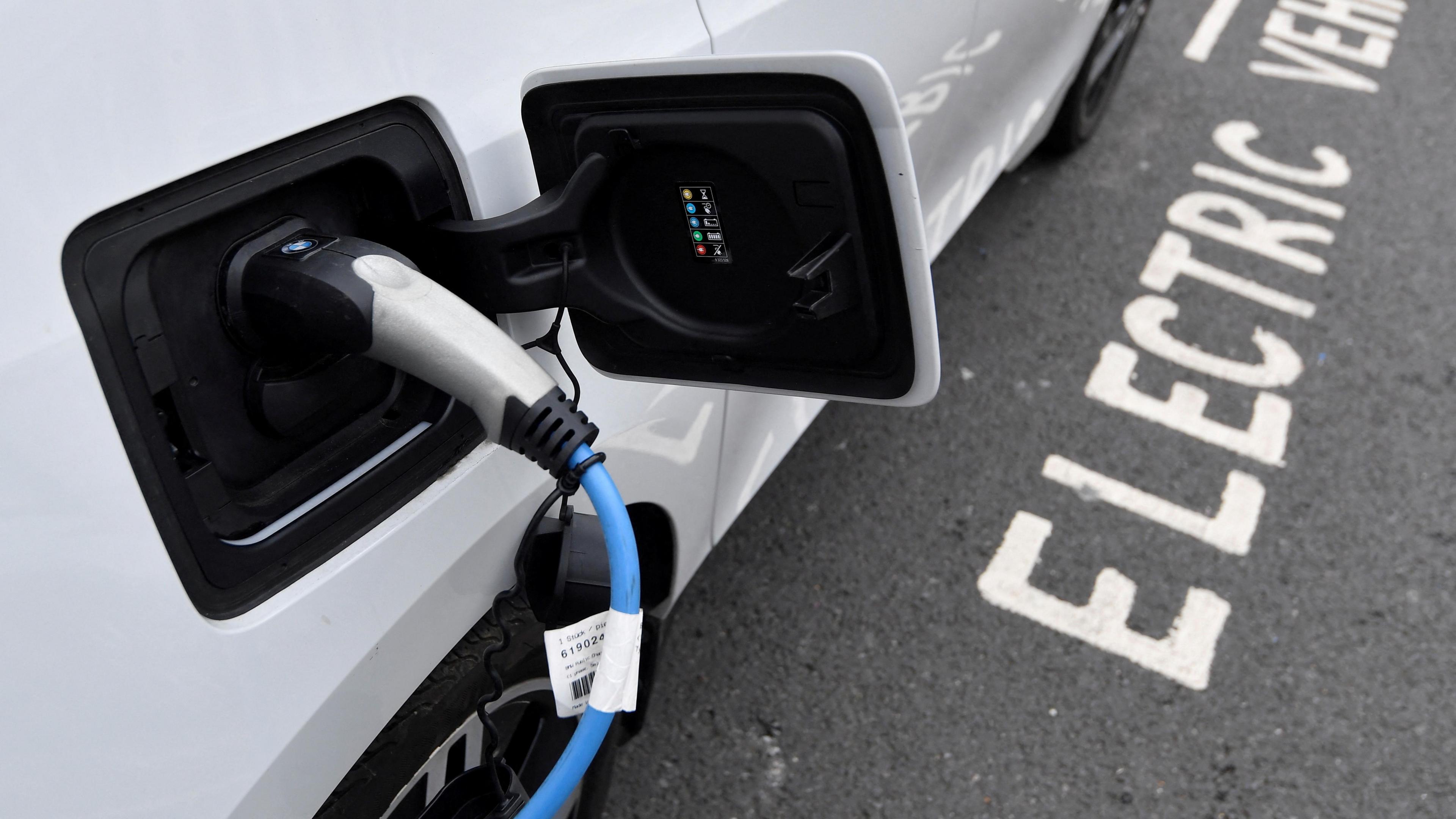 Electric car is charged at a roadside EV charge point