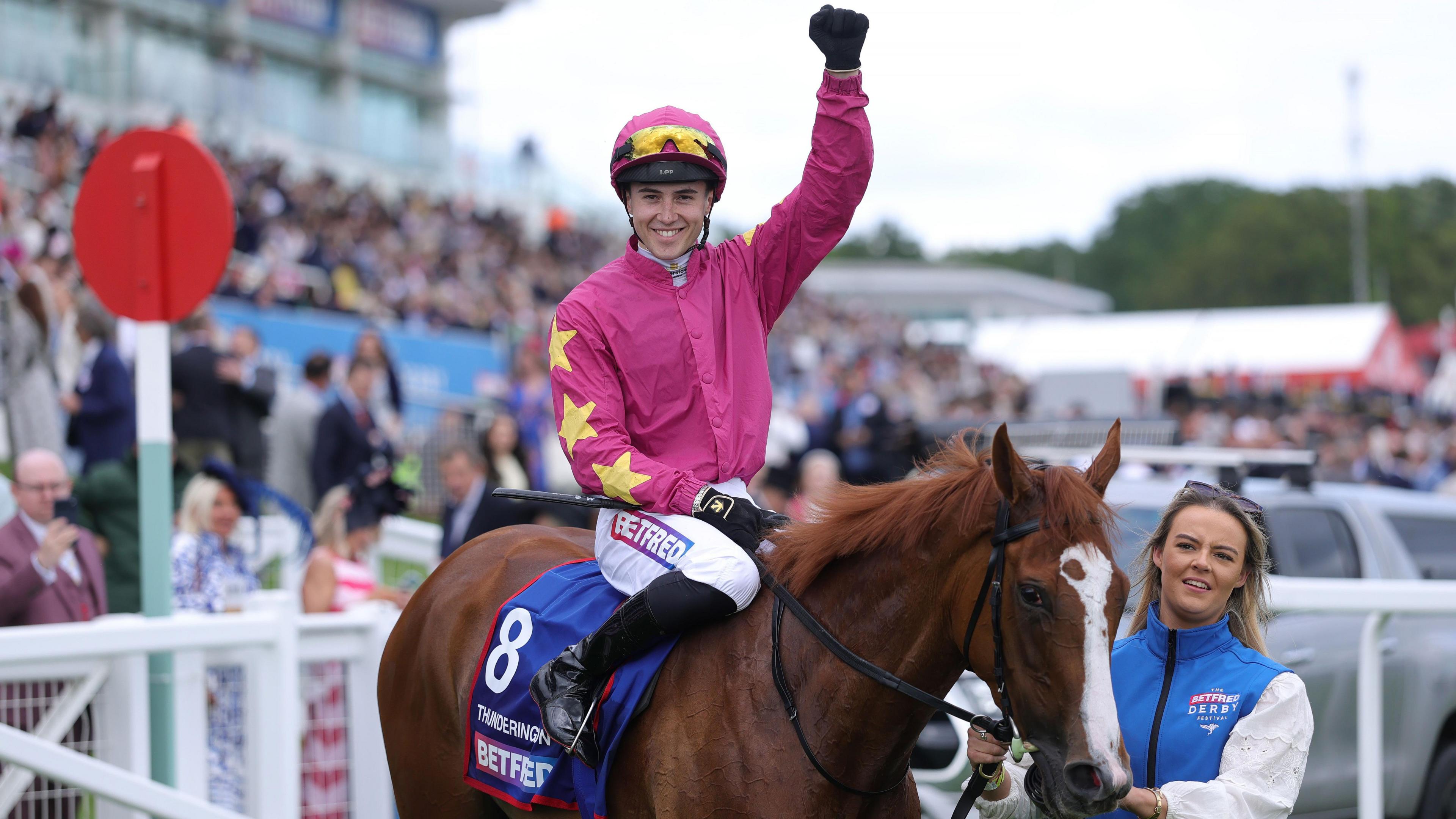Dylan Browne McMonagle raises his fist in their in triumph aboard Thundering On at Epsom