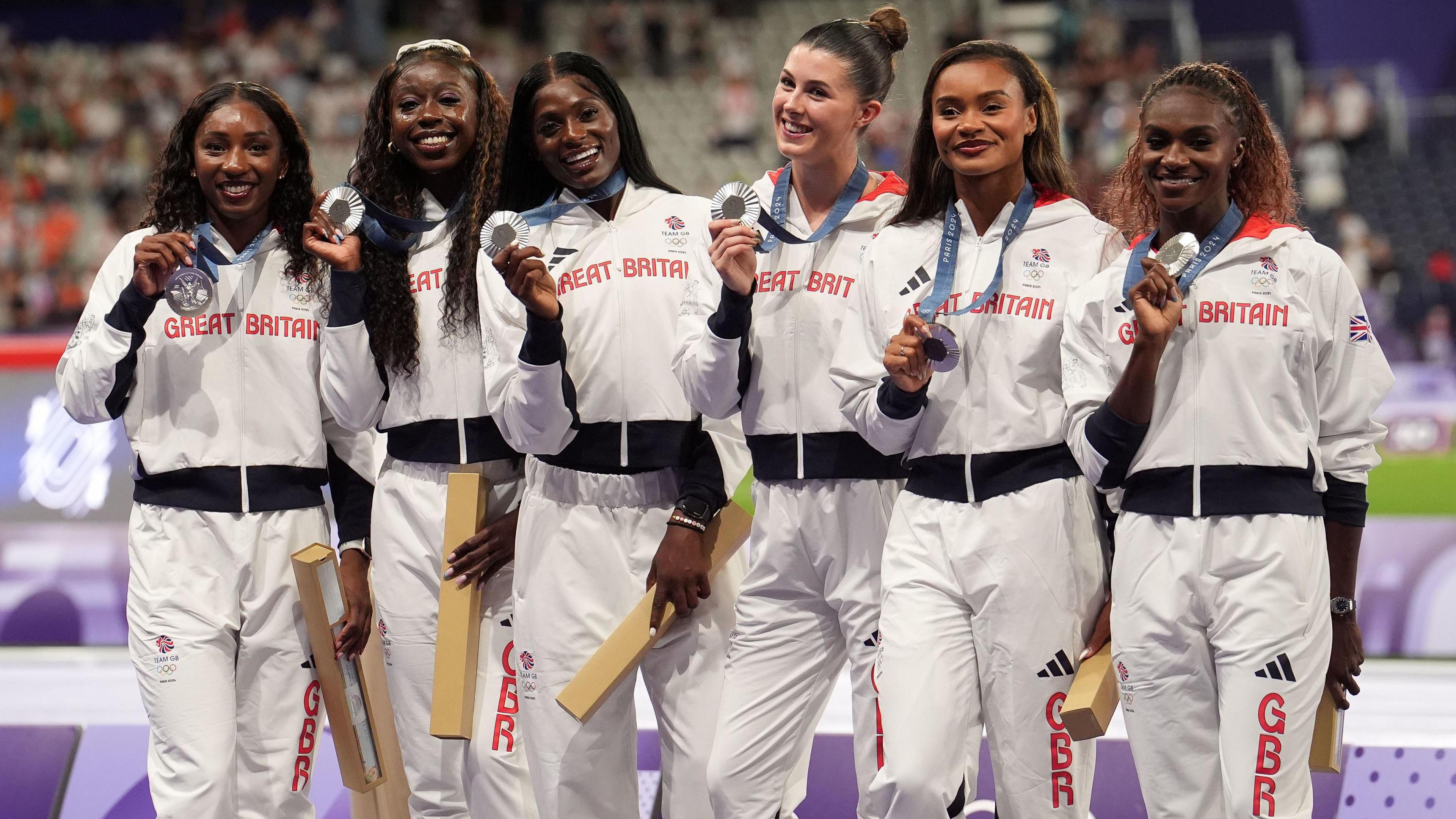 Great Britain's Amy Hunt, Dina Asher-Smith, Desiree Henry, Imani Lansiquot, Daryll Neita and Bianca Williams celebrate with their silver medals during the medal ceremony for the Women's 4 x 100m Relay Final