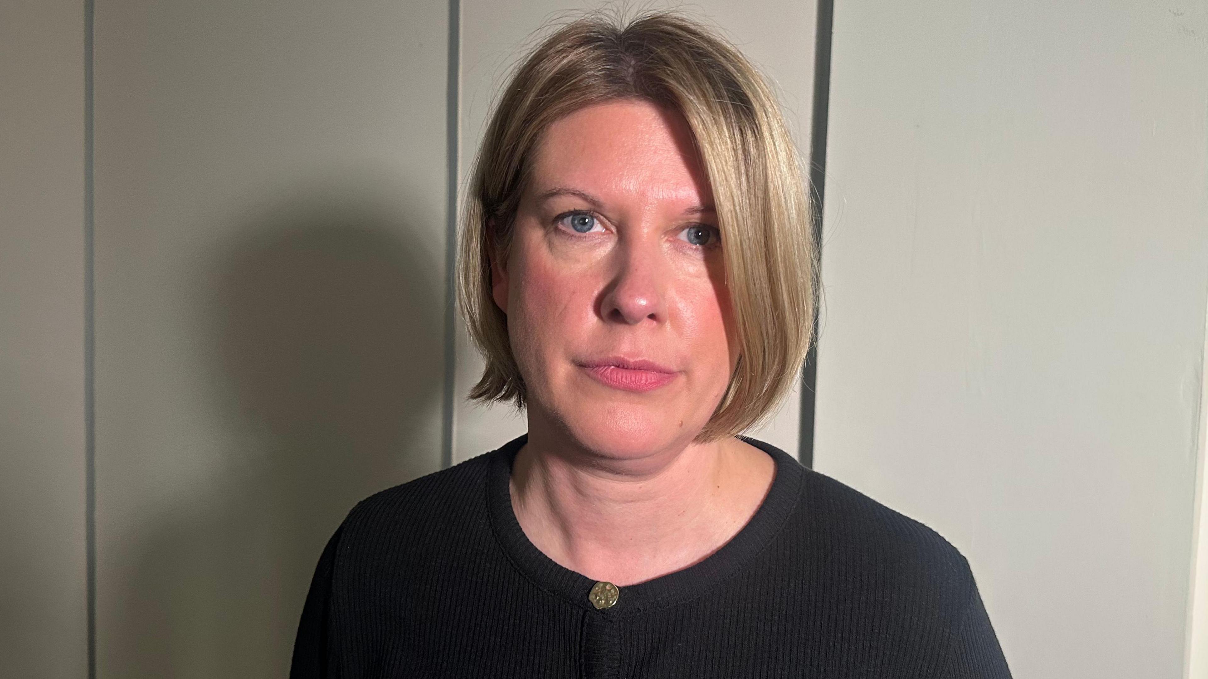 Detective superintendent Helen Schofield looking at the camera. She has blonde hair and is wearing a black top.