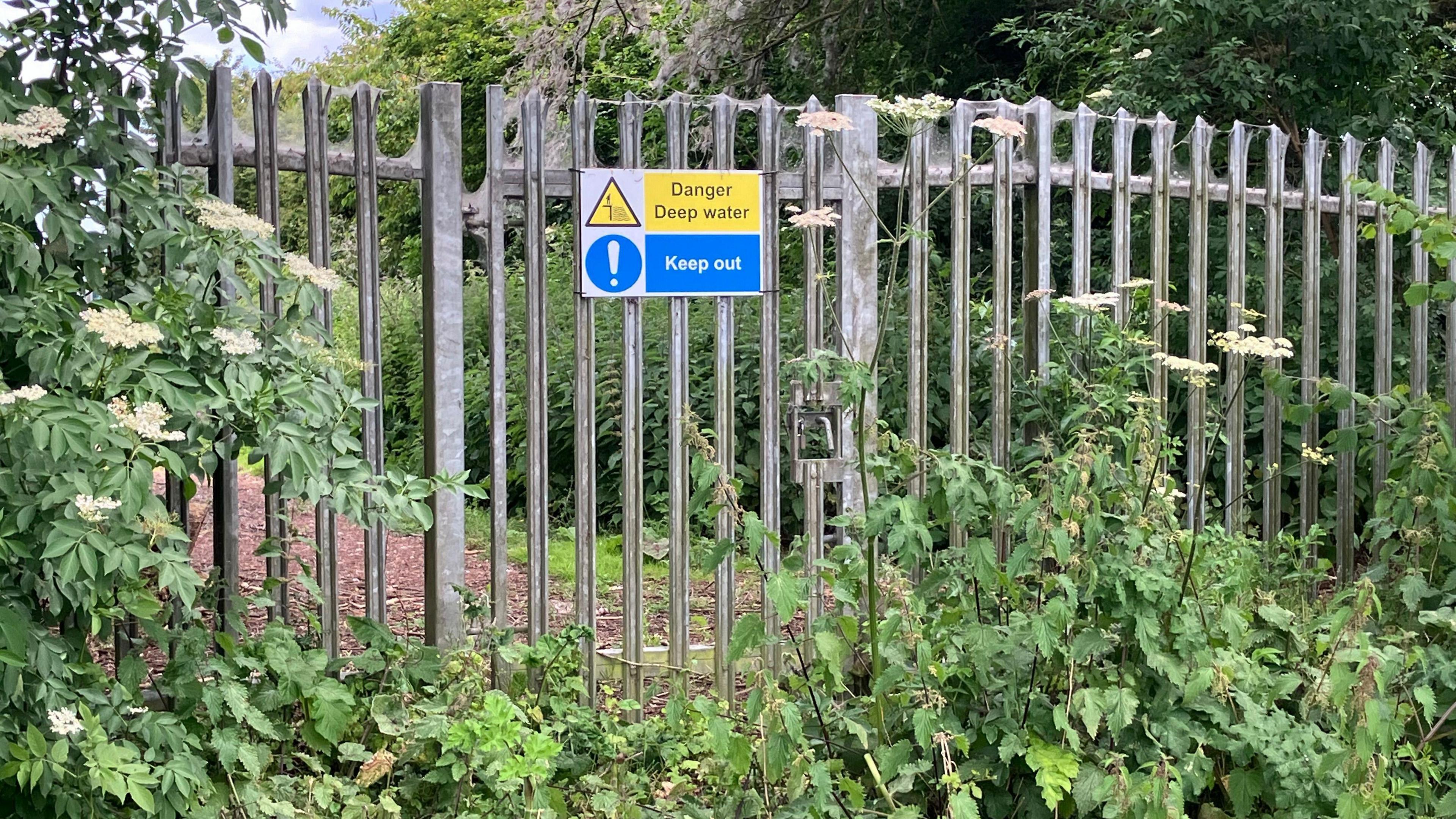 Witney's sewage treatment works with a sign saying: "danger, deep water" and "keep out!"