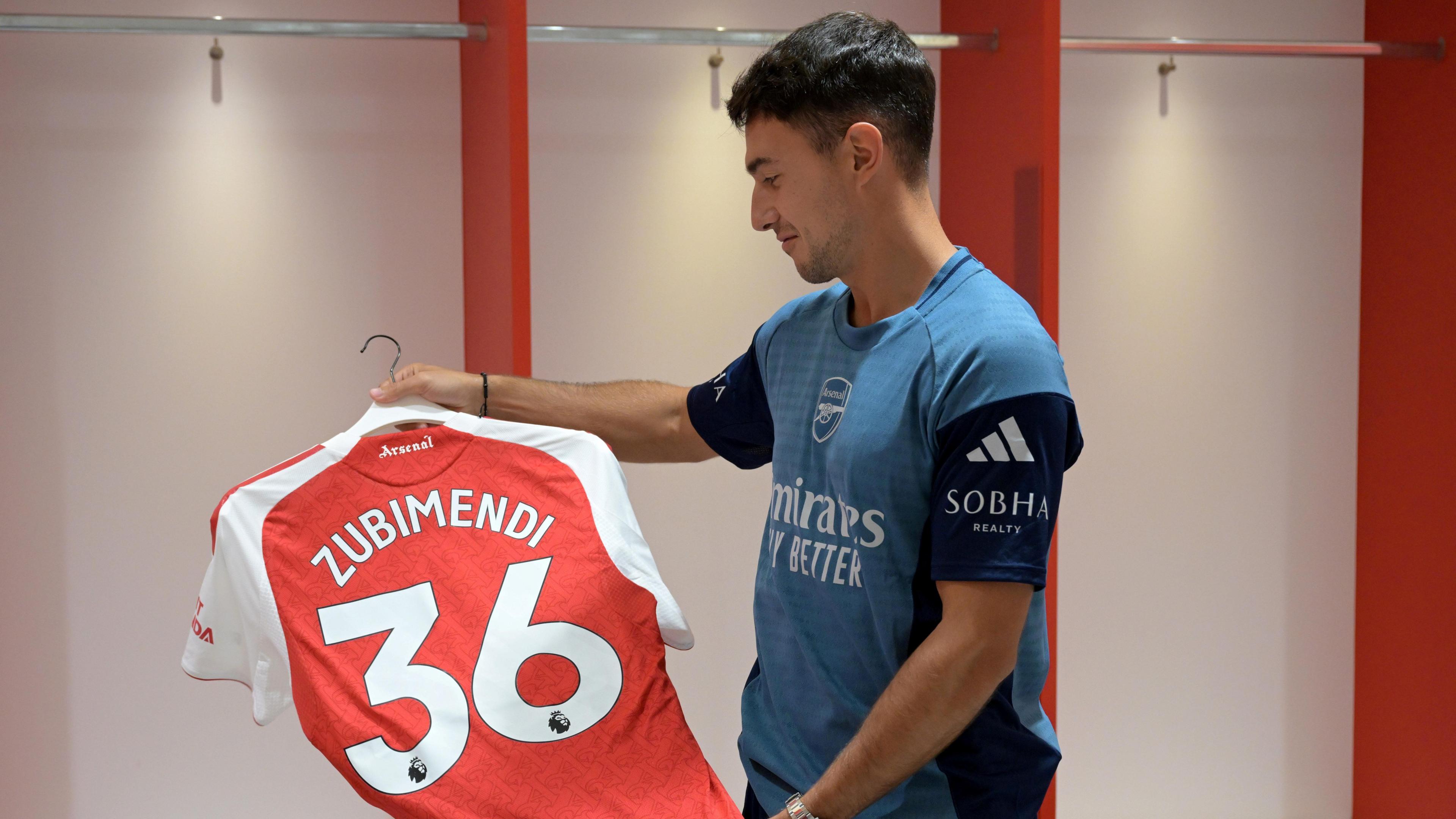 Martin Zubimendi looks at his Arsenal shirt with No.36 on it