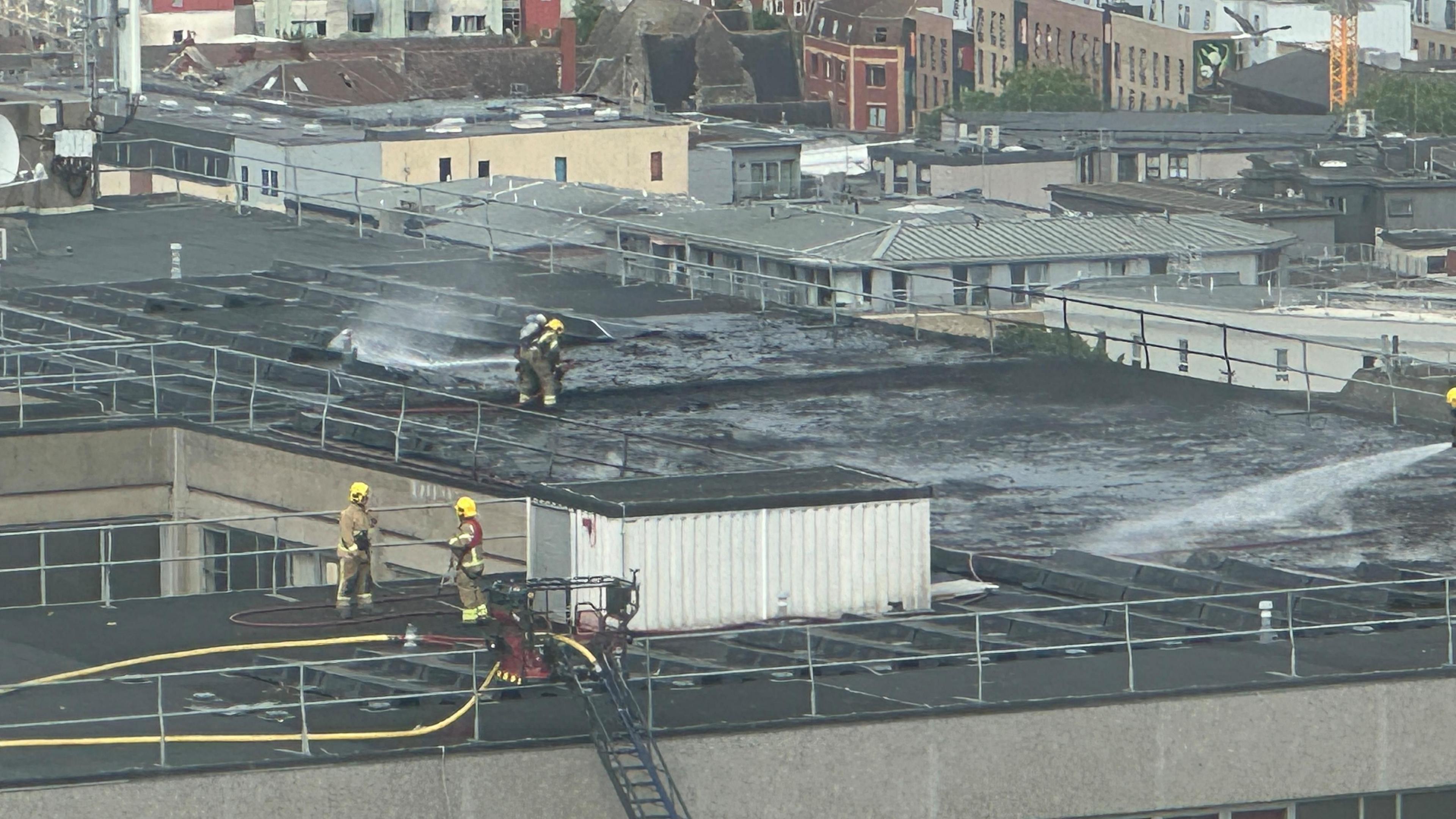 Firefighters dampening down the roof of St Michael's Hospital where a fire broke out.