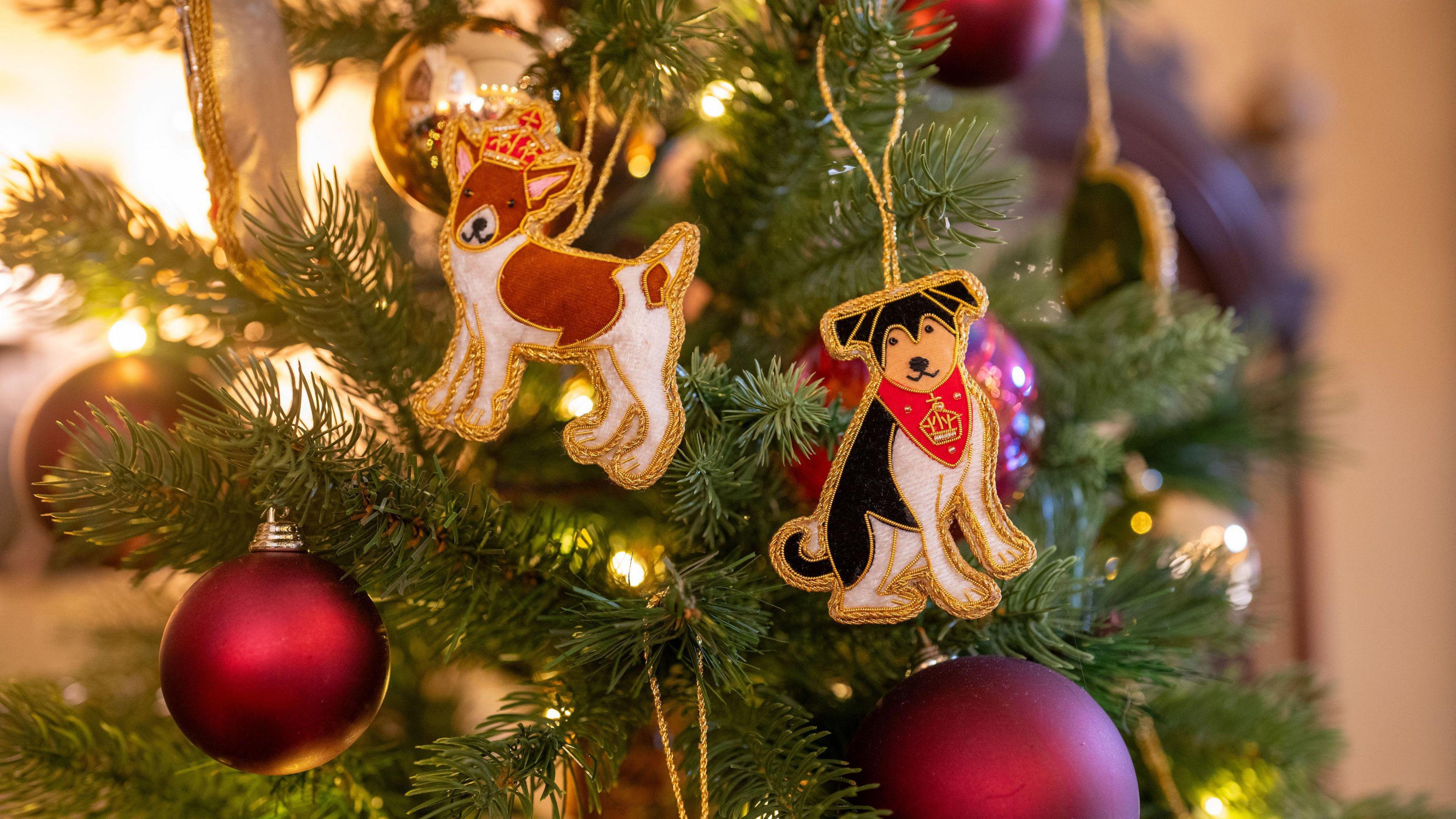 A Christmas tree decoration at Highgrove Gardens as staff prepare to welcome the public for Christmas celebrations in the Orchard Room, the estate's dedicated entertaining space. Two dogs are among the decorations alongside large red baubles