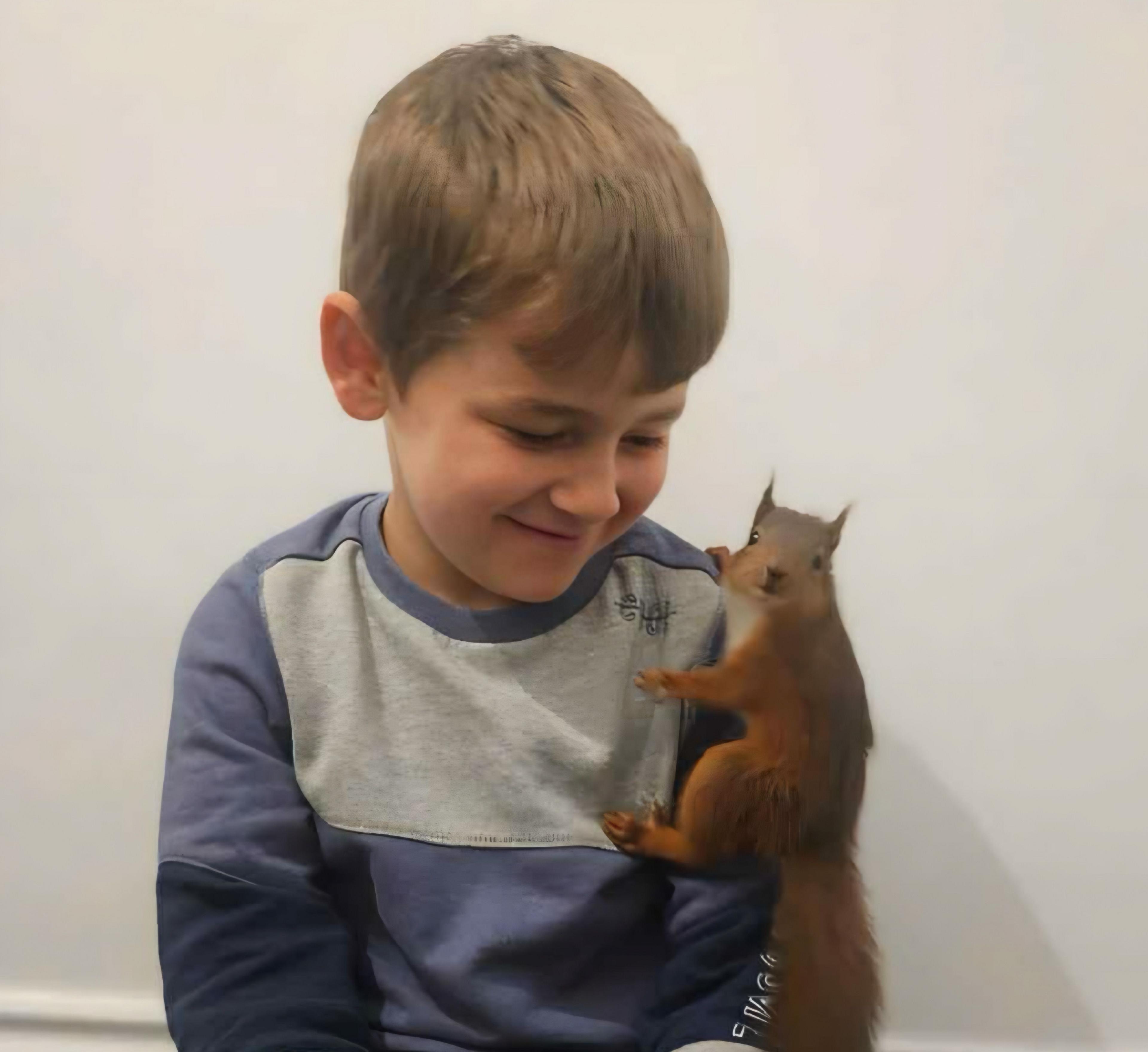 Phoenix with a red squirrel on his left shoulder.