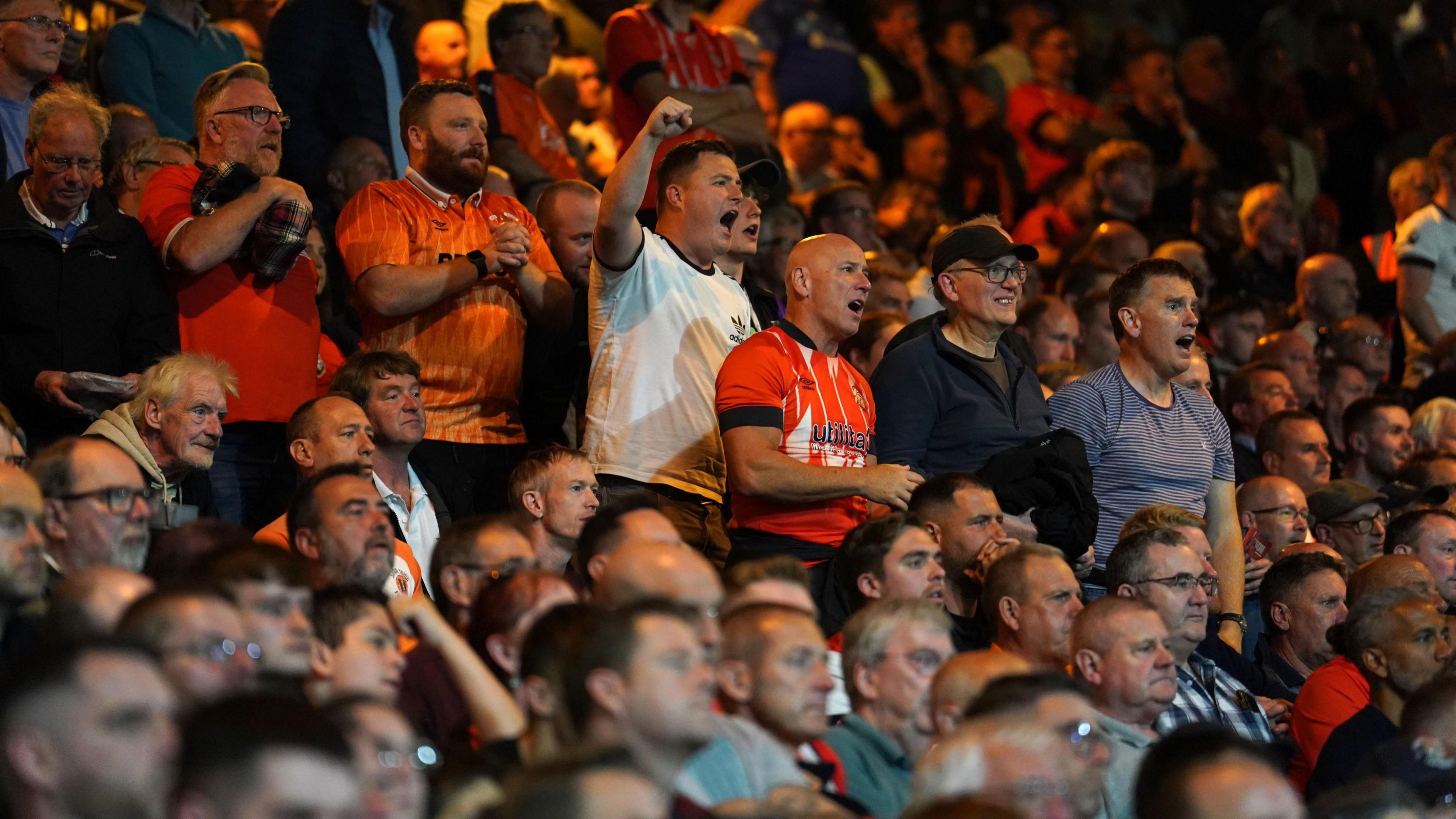 Luton Town fans watch their team