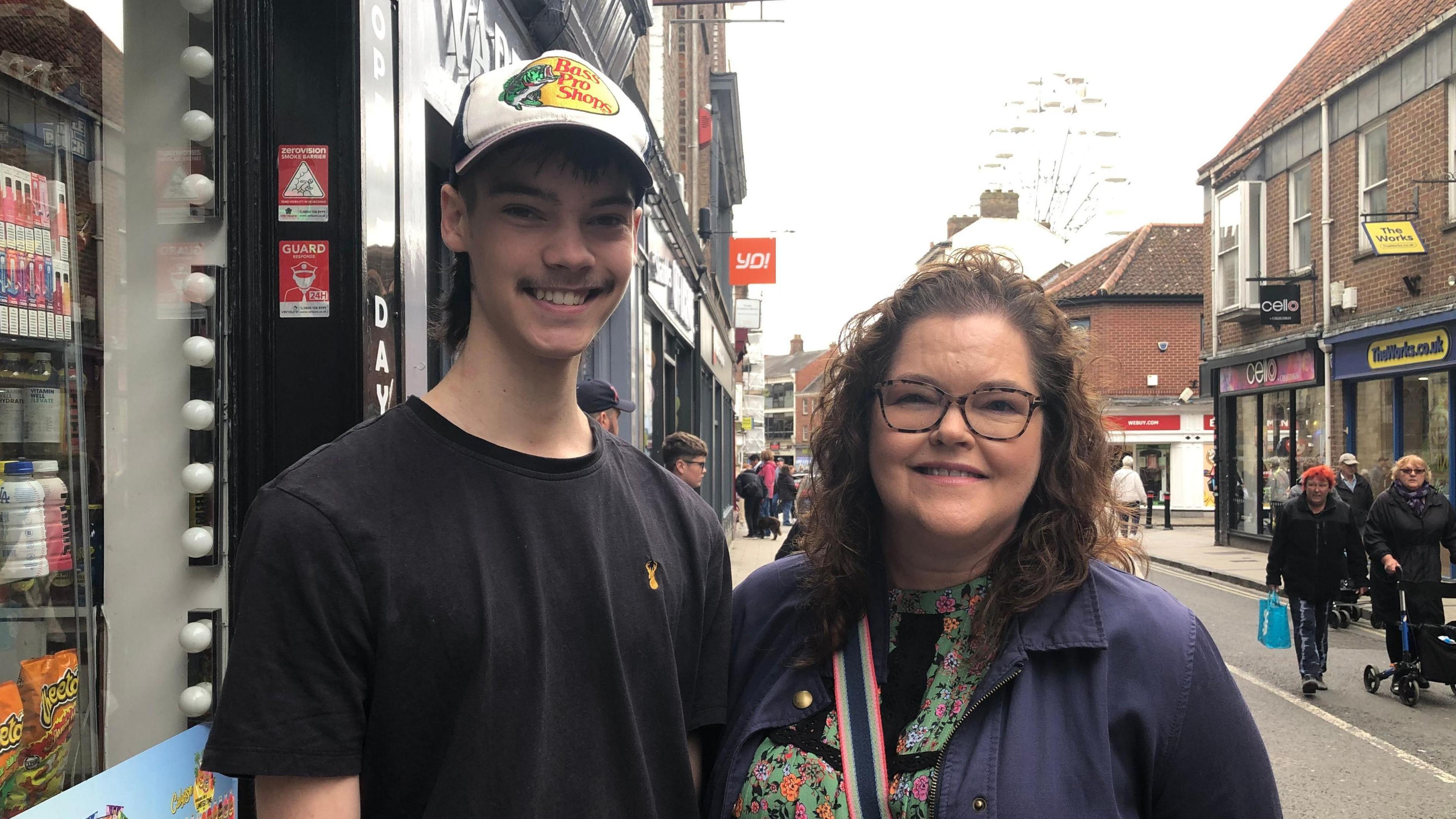 Son and mum stood on street