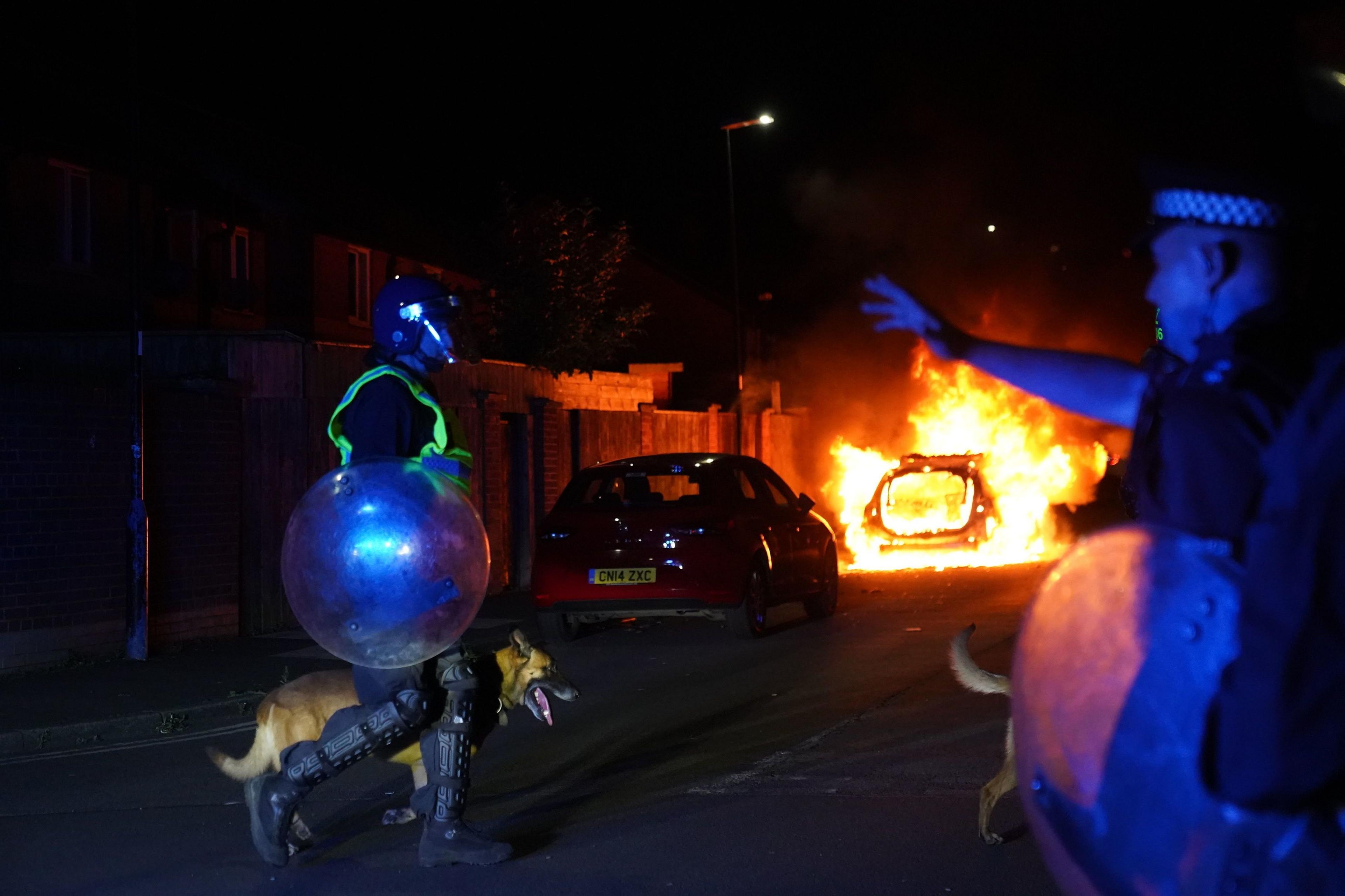 A police car burns as officers are deployed on the streets of Hartlepool following a violent protest.