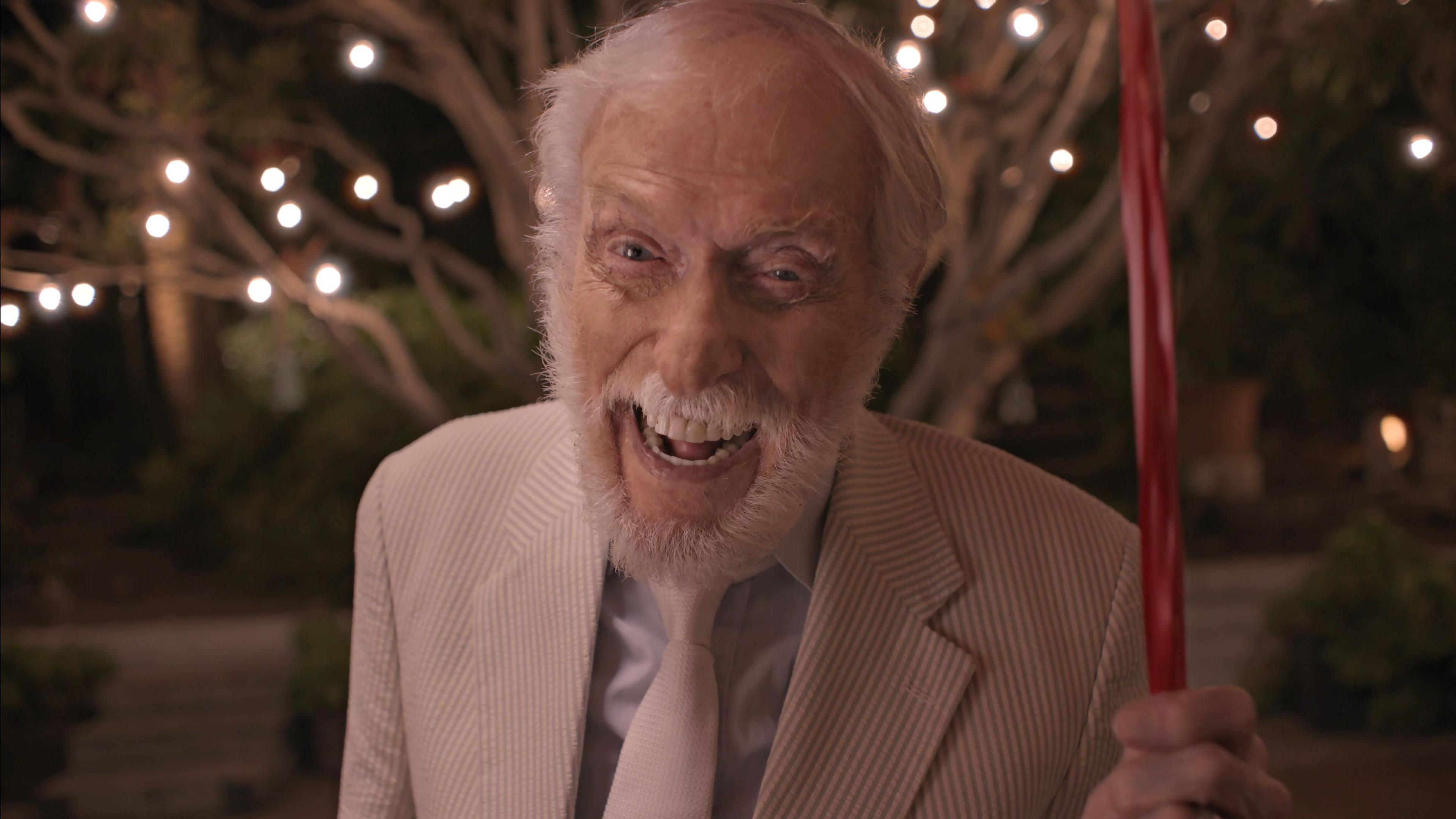 Dick Van Dyke holds a candy-cane umbrella, recreating a scene from Mary Poppins in the video for Coldplay's All My Love