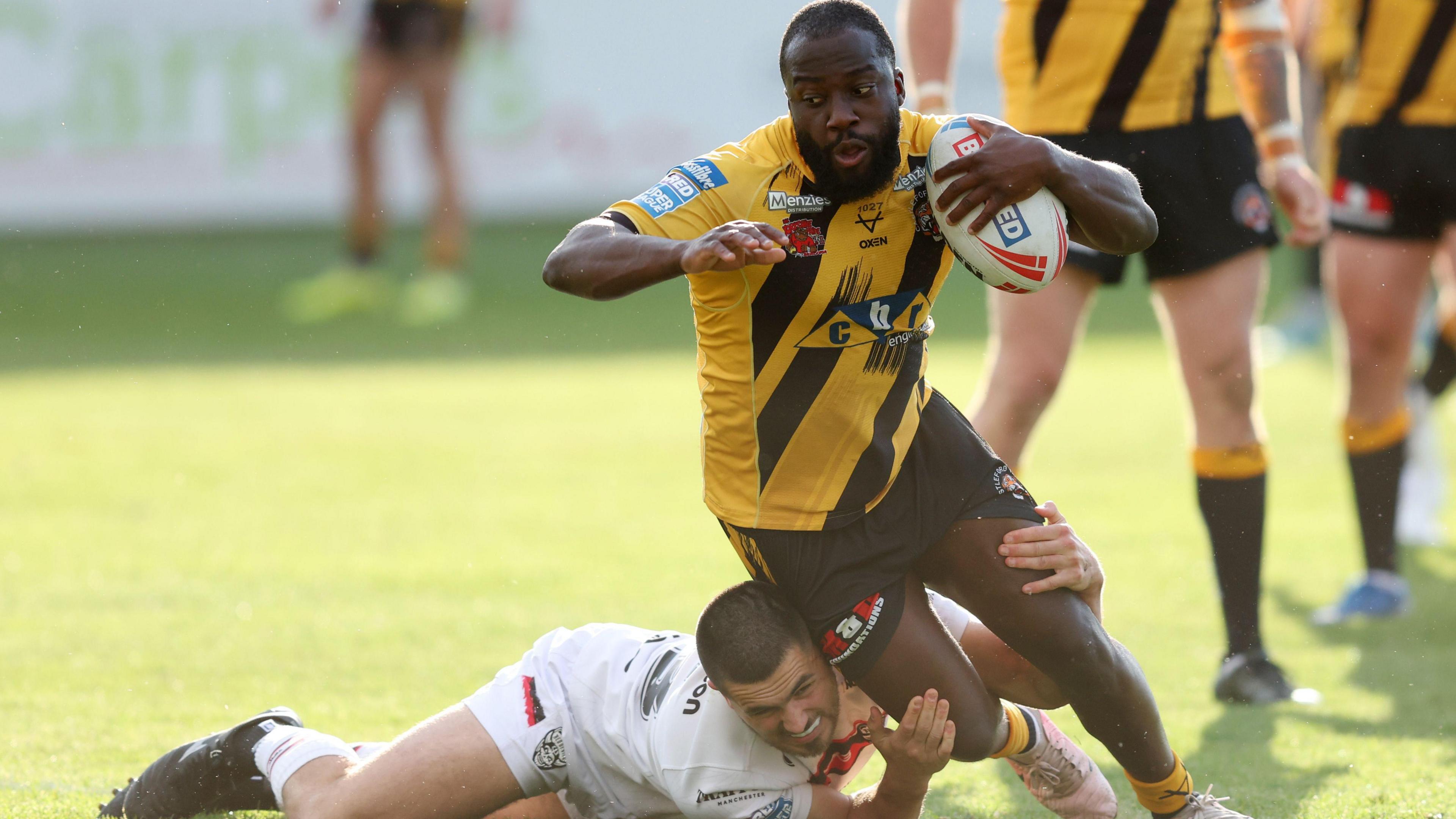 Muizz Mustapha is tackled during a game for Castleford