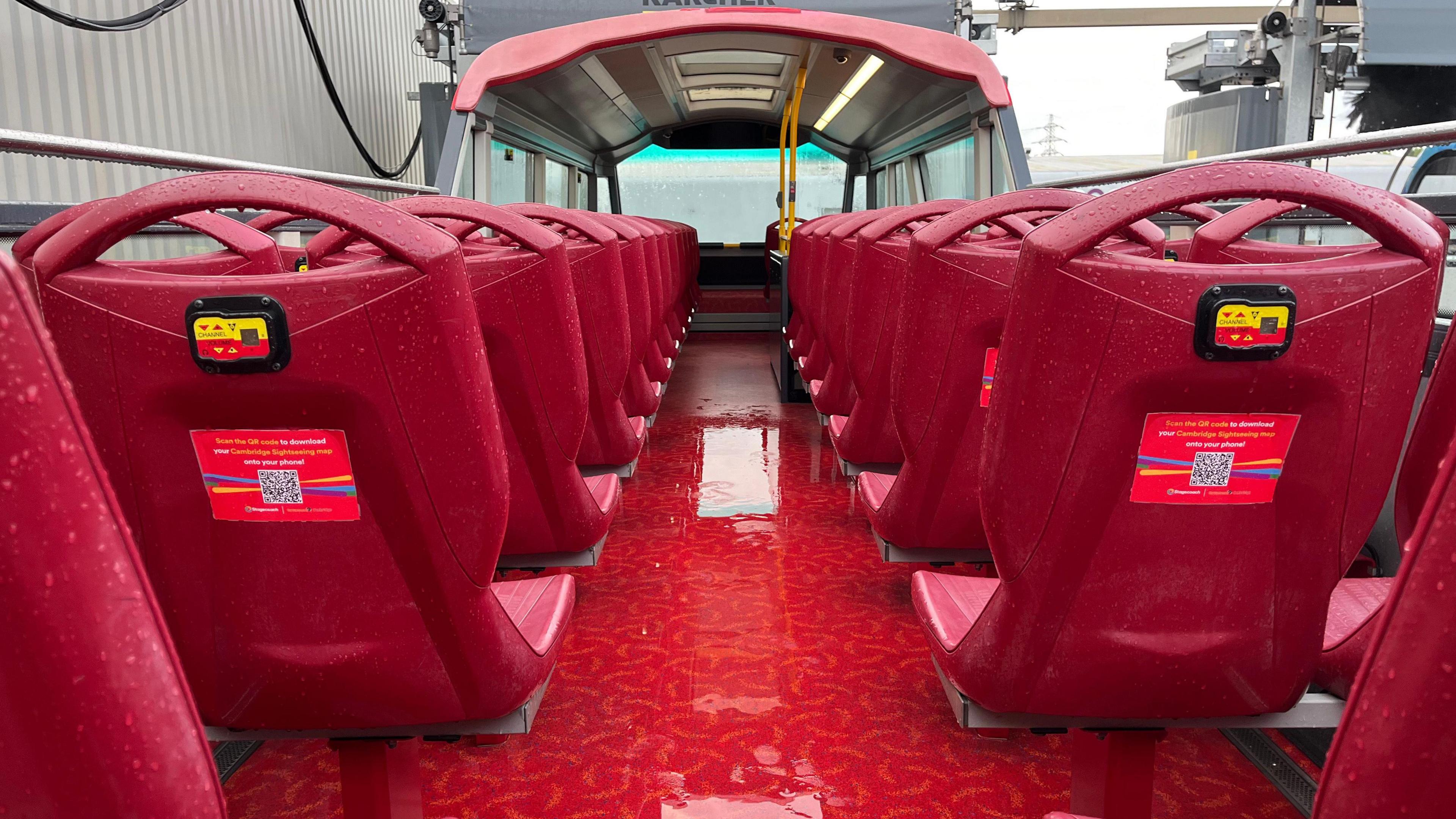 An open-top bus going through the new bus wash