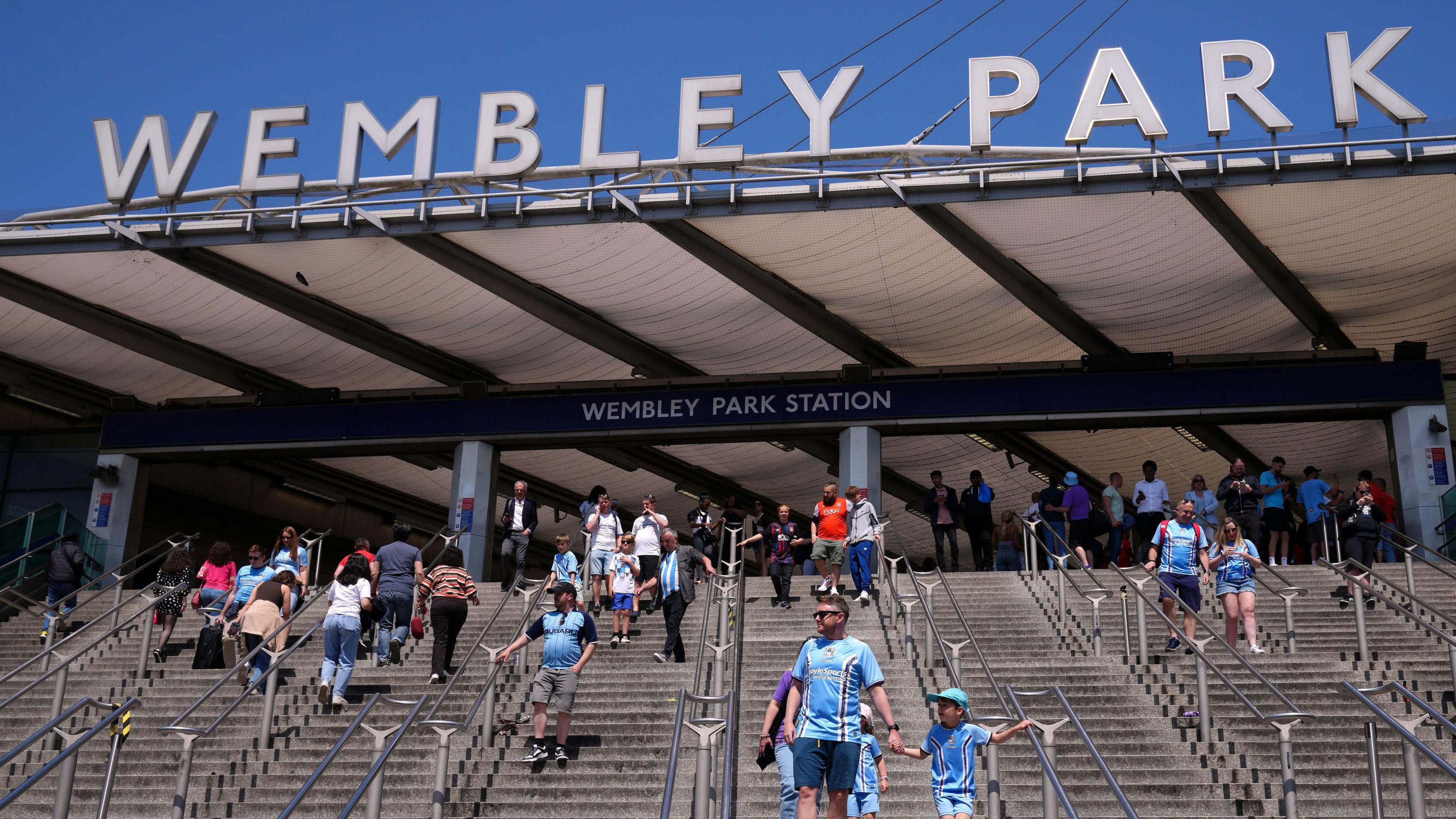 People make their way down the steps outside Wembley Park station