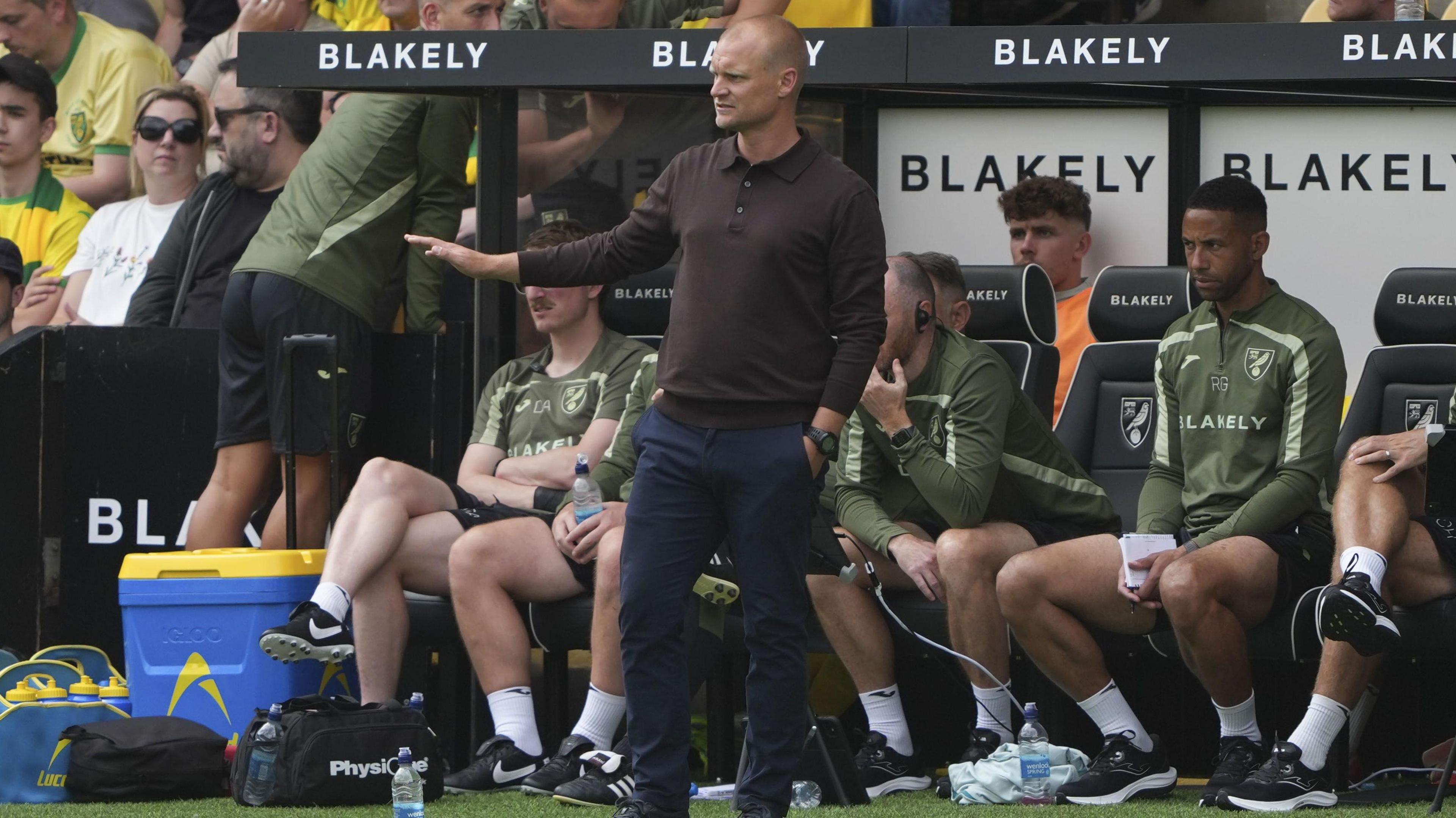 Liam Manning delivers instructions to his Norwich team