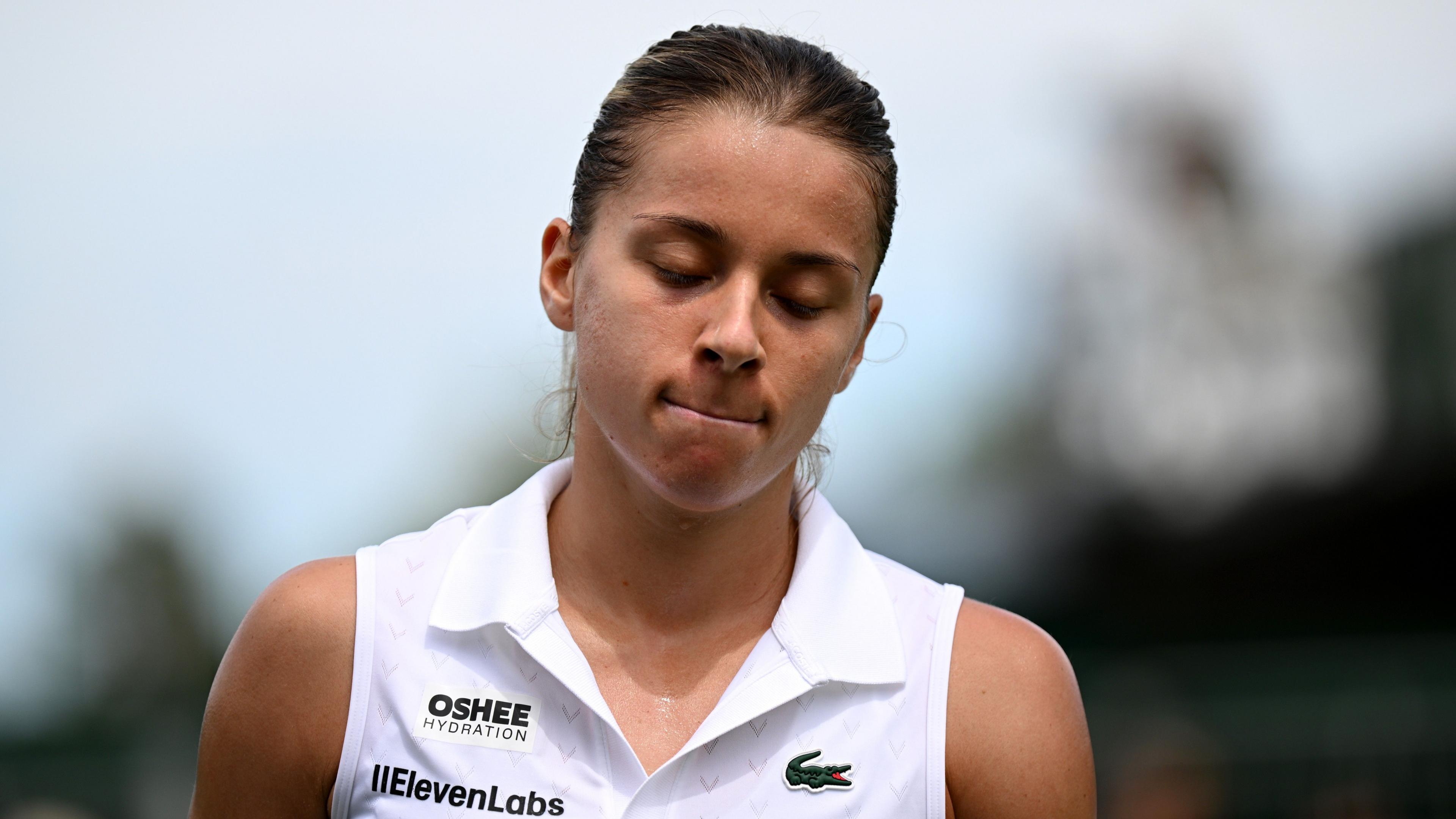 Maja Chwalinska grimaces after falling during her Wimbledon first-round match