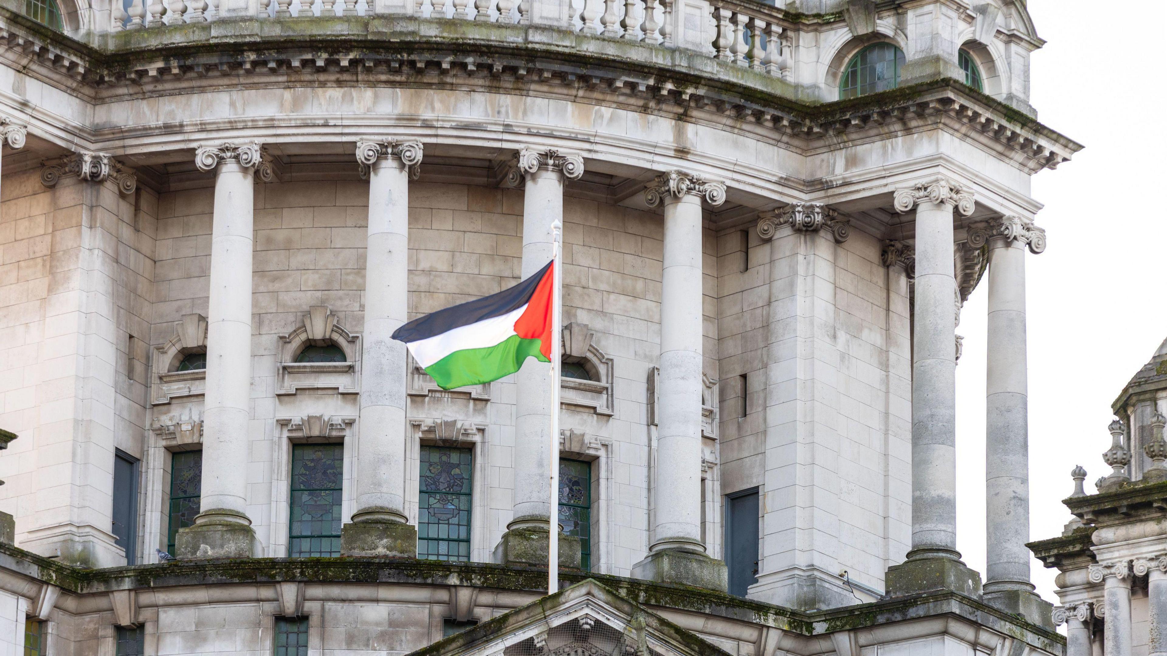 A Palestinian flag flying from Belfast City Hall.