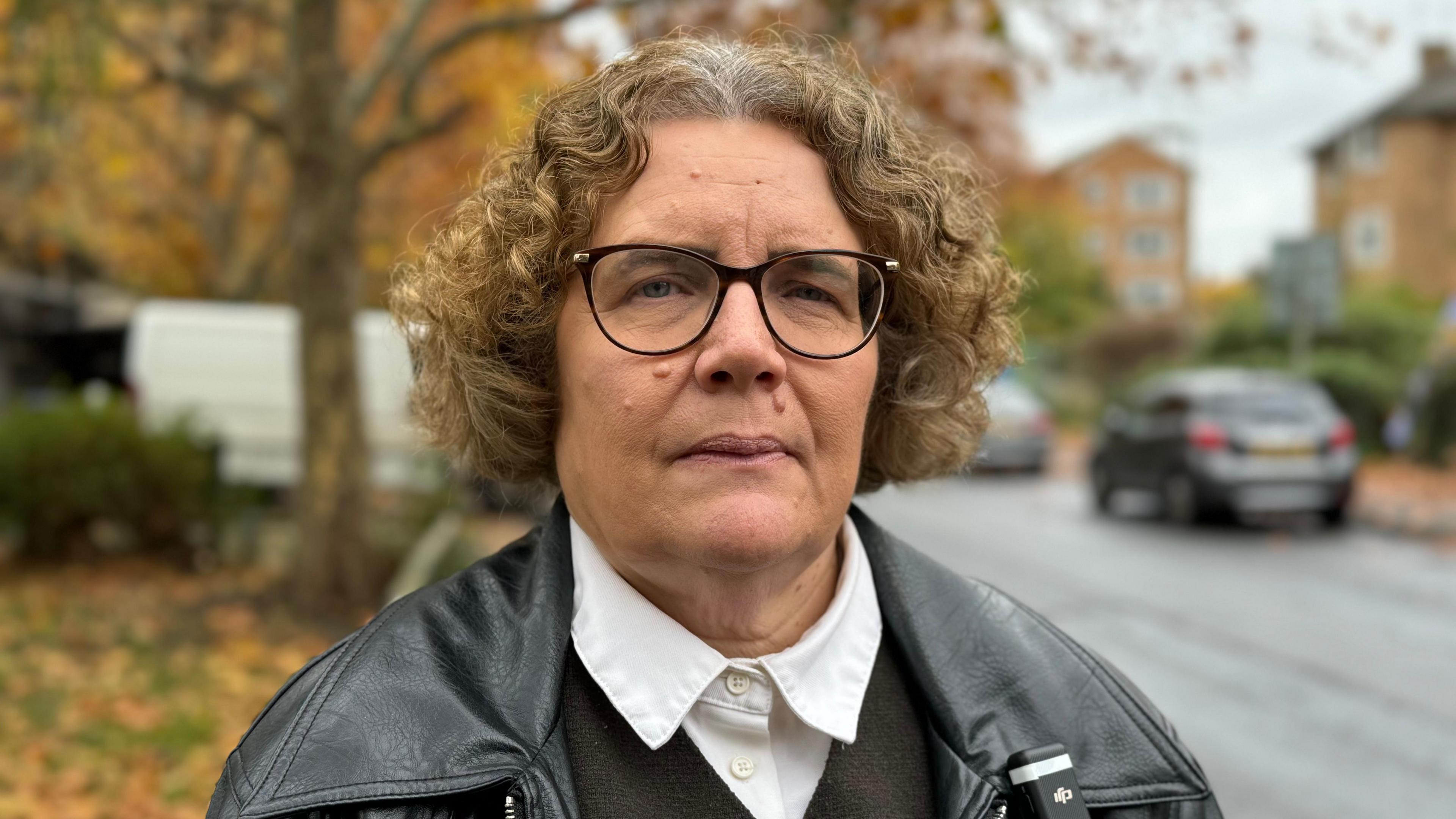 Ann-Marie Barker, the leader of Woking Borough Council, looks straight at the camera.